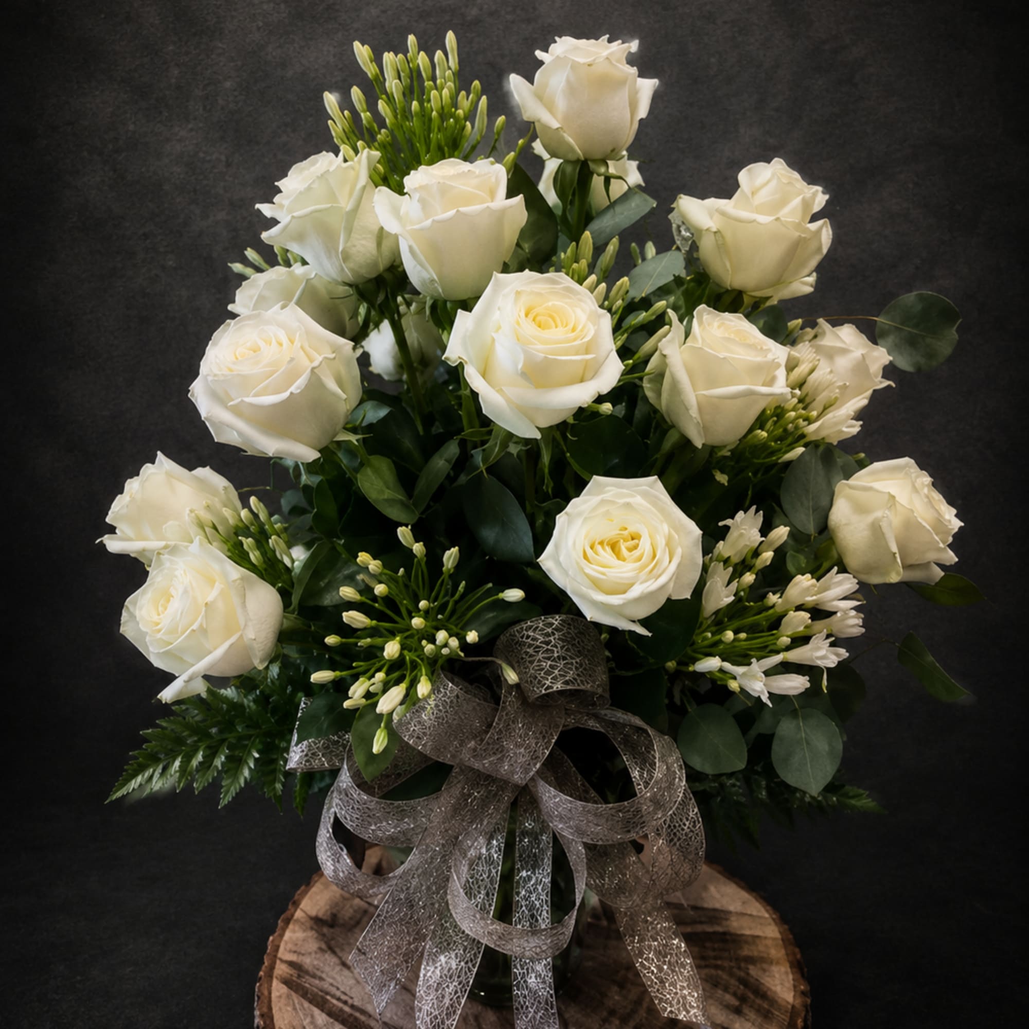 Let's celebrate any occasion with 20 white roses intricately arranged with white