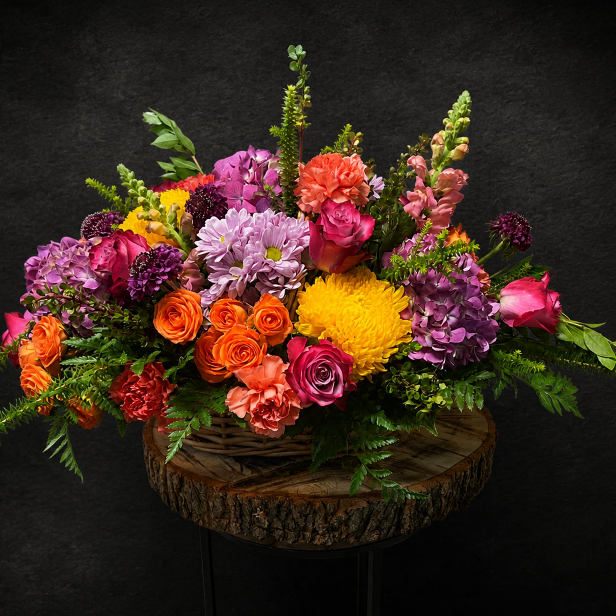 Lively pinks, purples, oranges and sunny yellows burst from a rustic woven