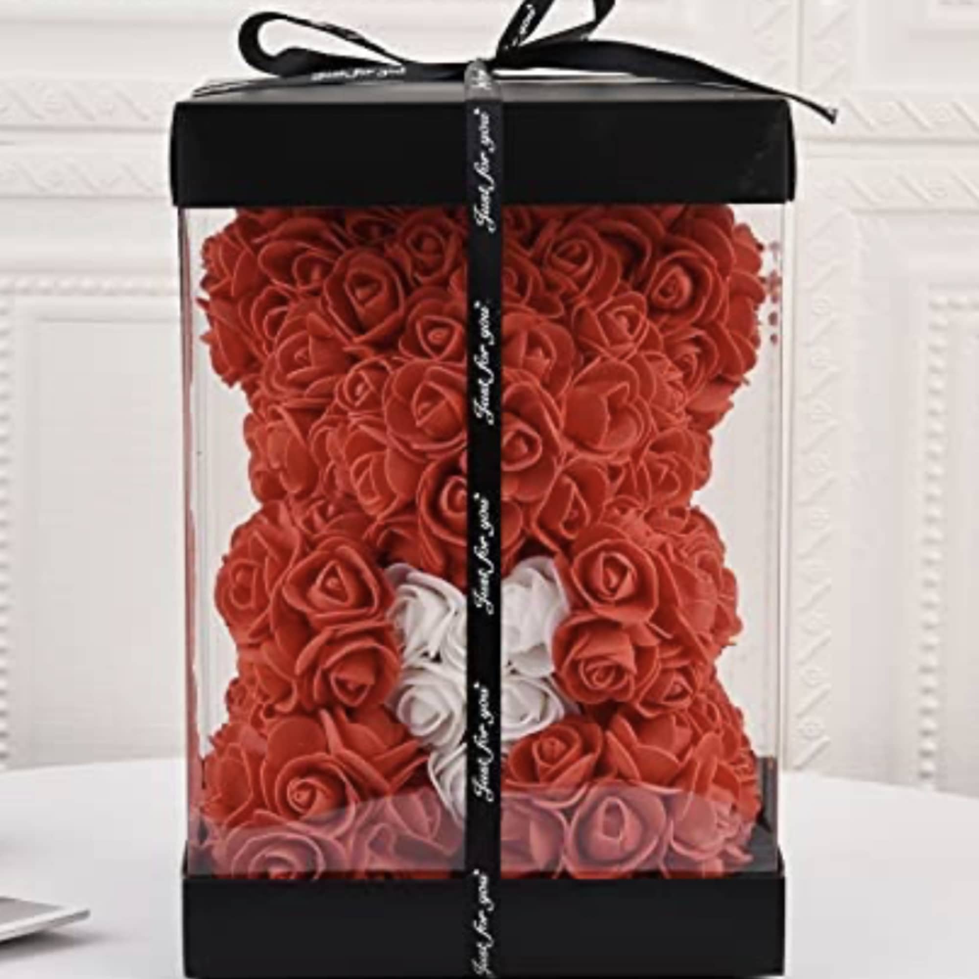 Red rose teddy bear in a clear gift box with a black ribbon