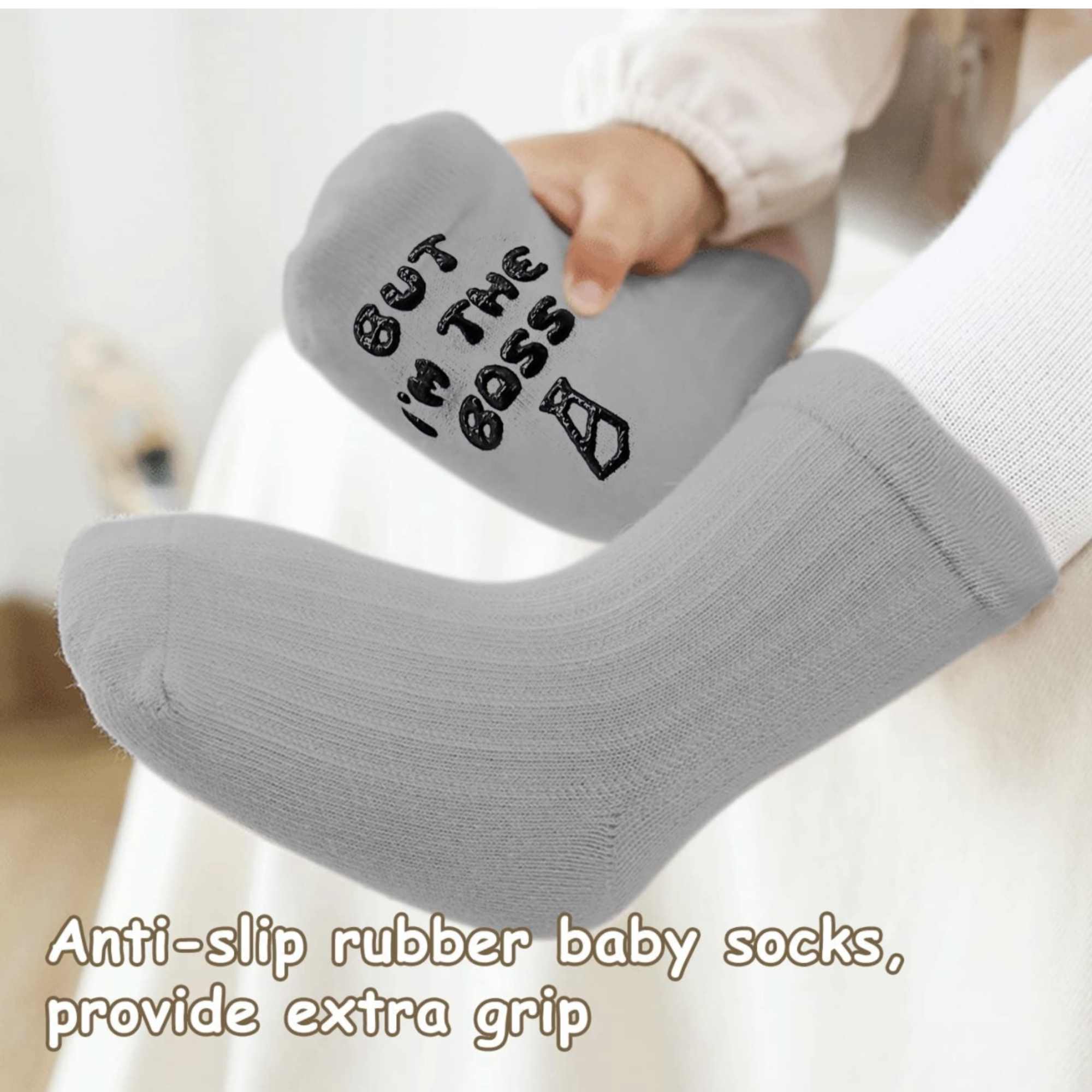 Gray baby socks with anti-slip soles and text on them