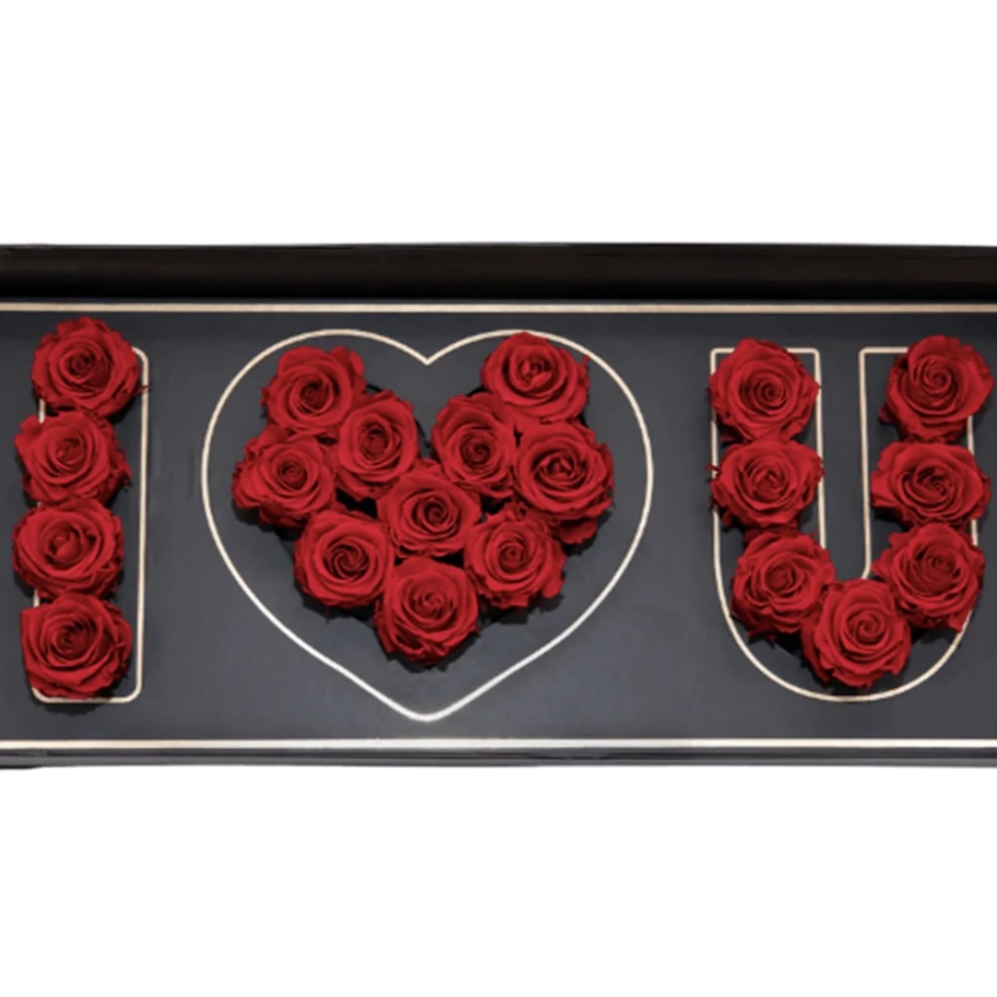 Red roses arranged to spell I heart U in a black box