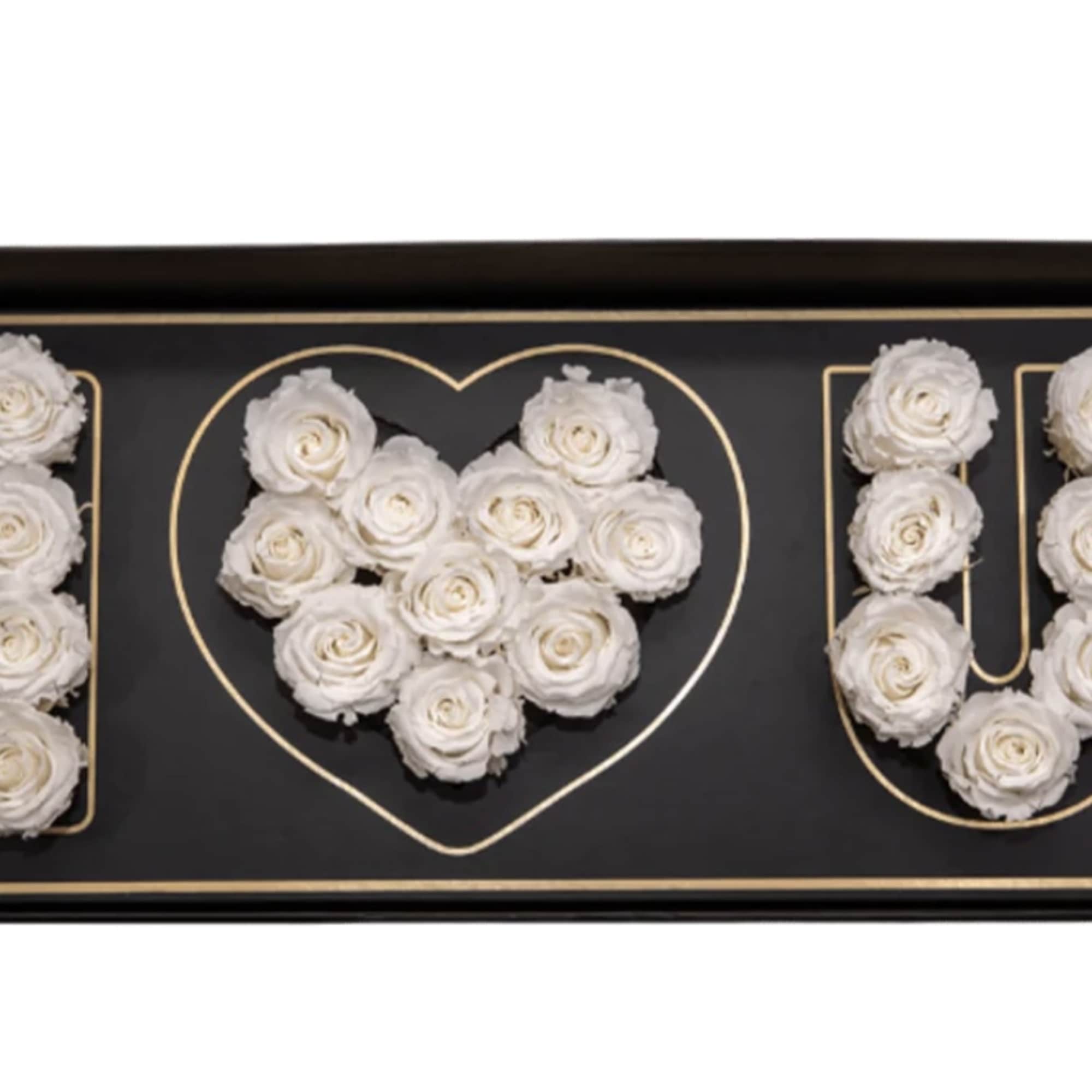 White roses arranged to spell I love U in a black gift box