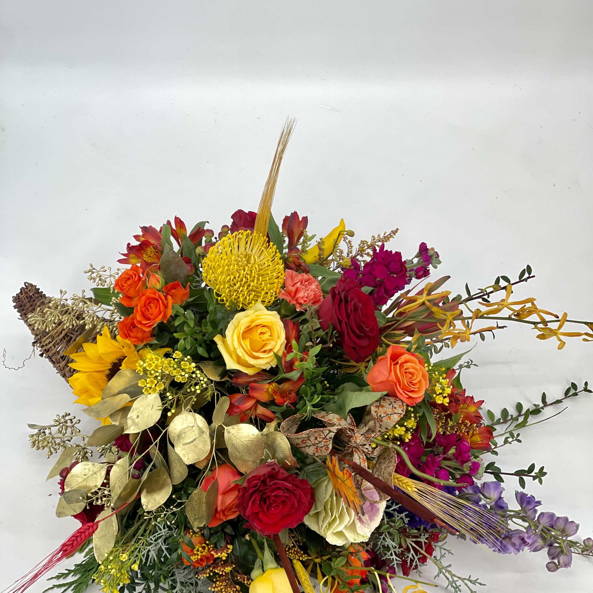 Colorful mixed bouquet with roses, sunflowers, and tropical accents