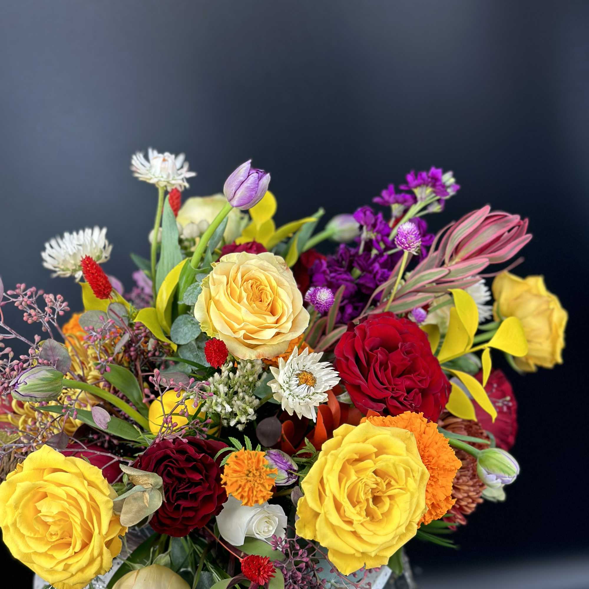 Colorful bouquet of roses, tulips, and small accent flowers