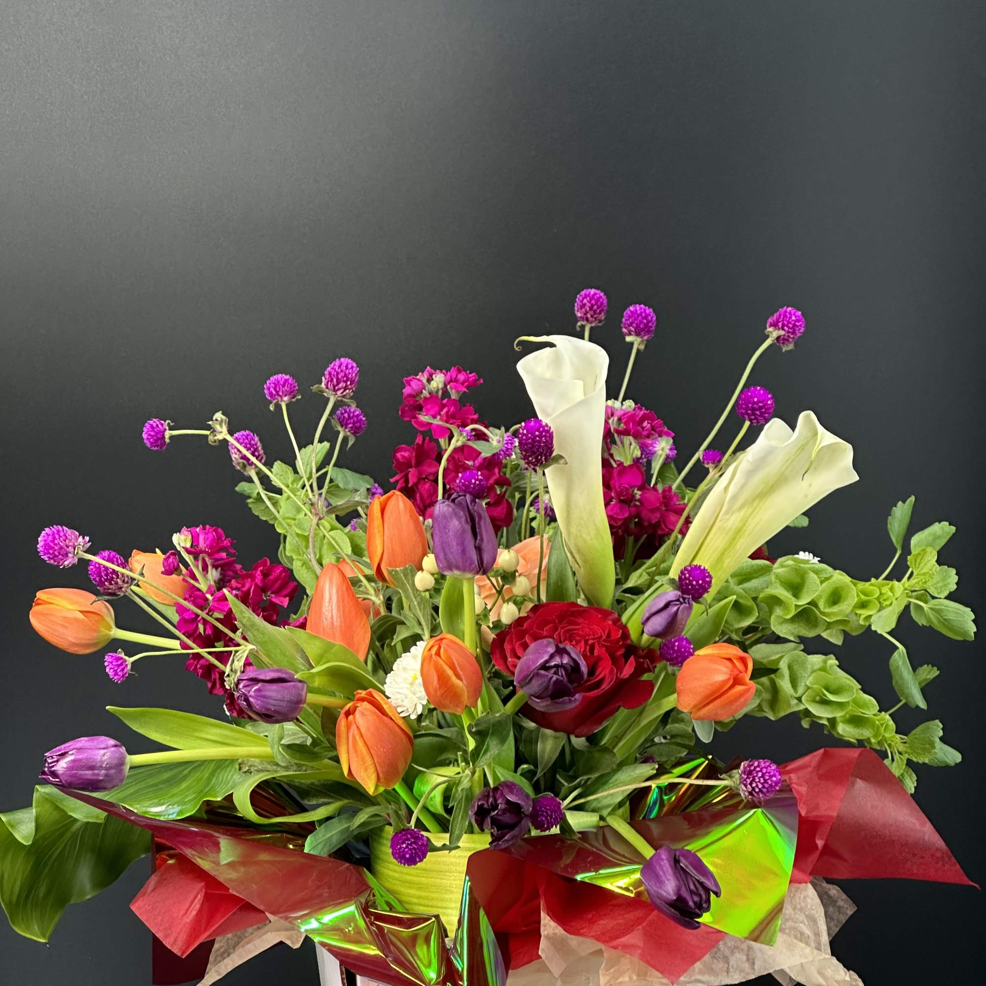 A designer-crafted arrangement featuring premium seasonal blooms ,thoughtfully styled and finished in