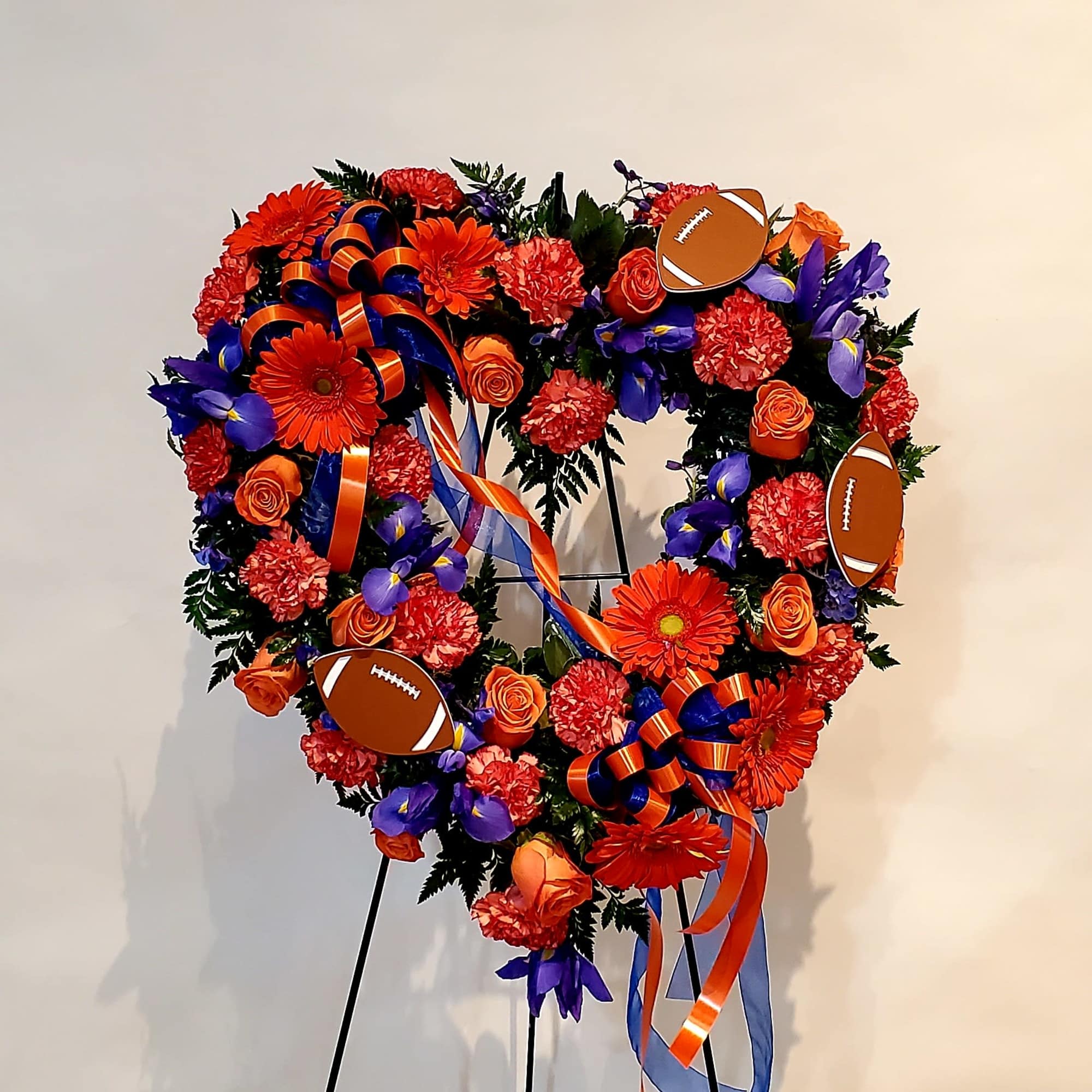 Heart-shaped floral wreath with orange, red, and purple flowers