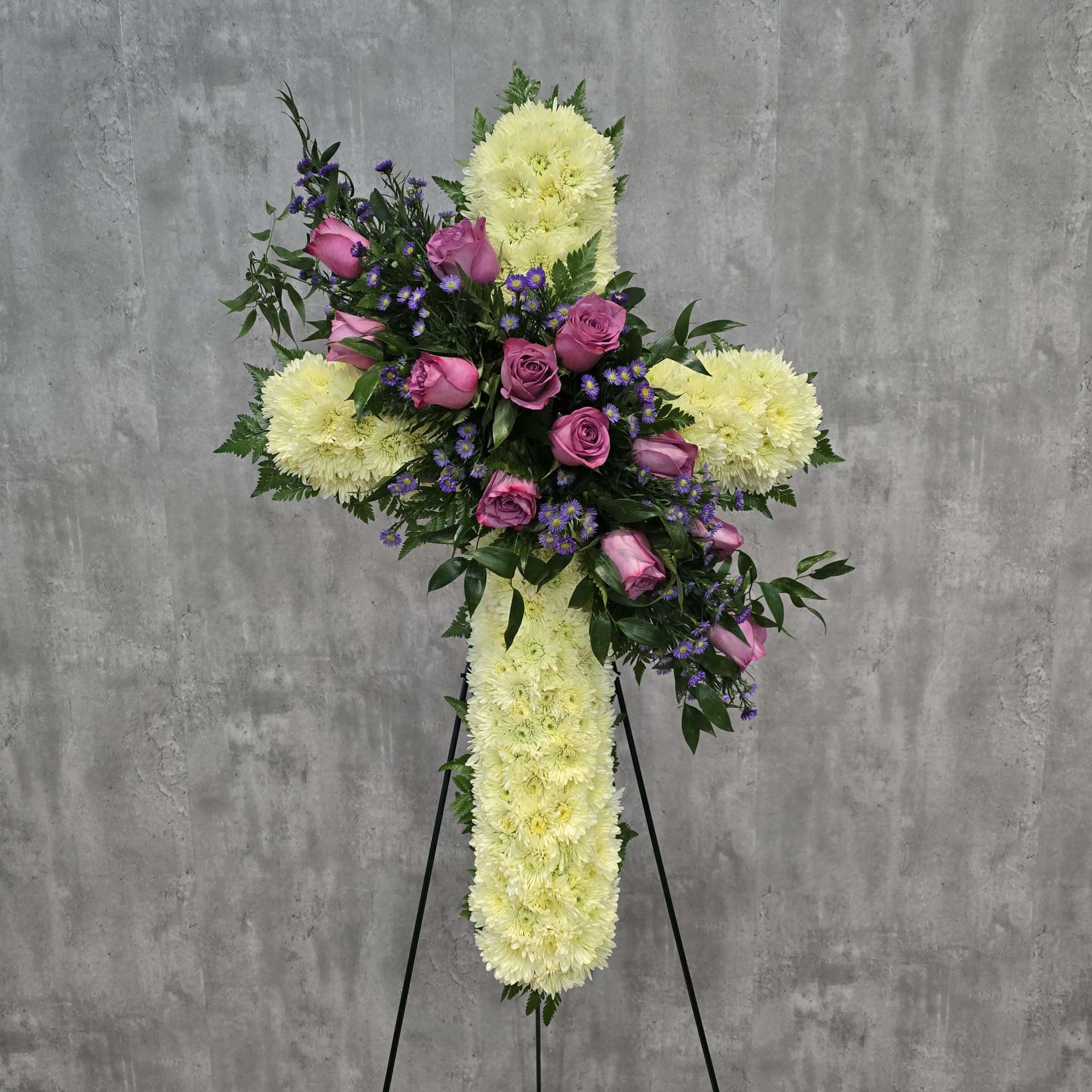 Cross-shaped floral standing spray with pink roses and pale yellow chrysanthemums