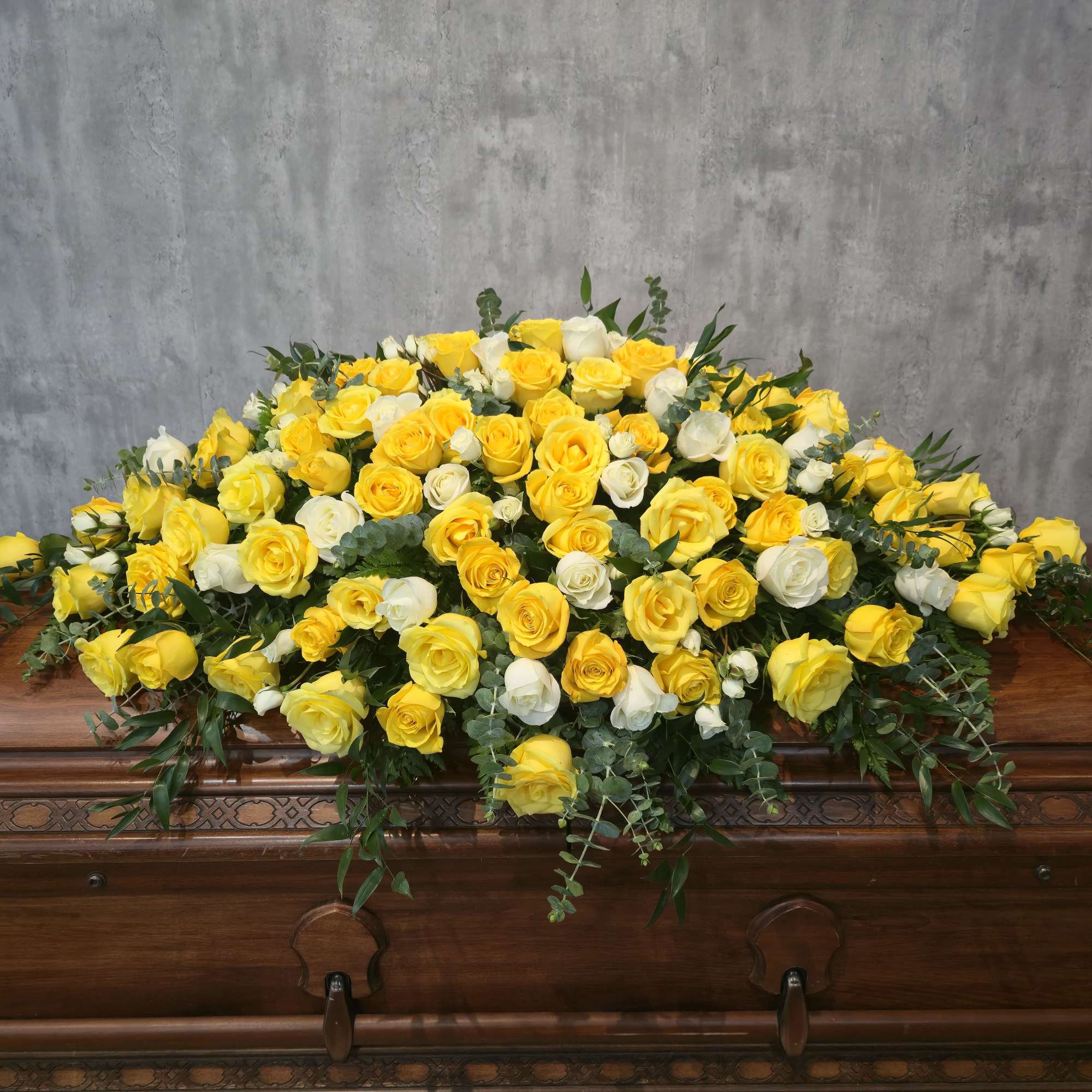 A gorgeous casket spray of white and pink roses.