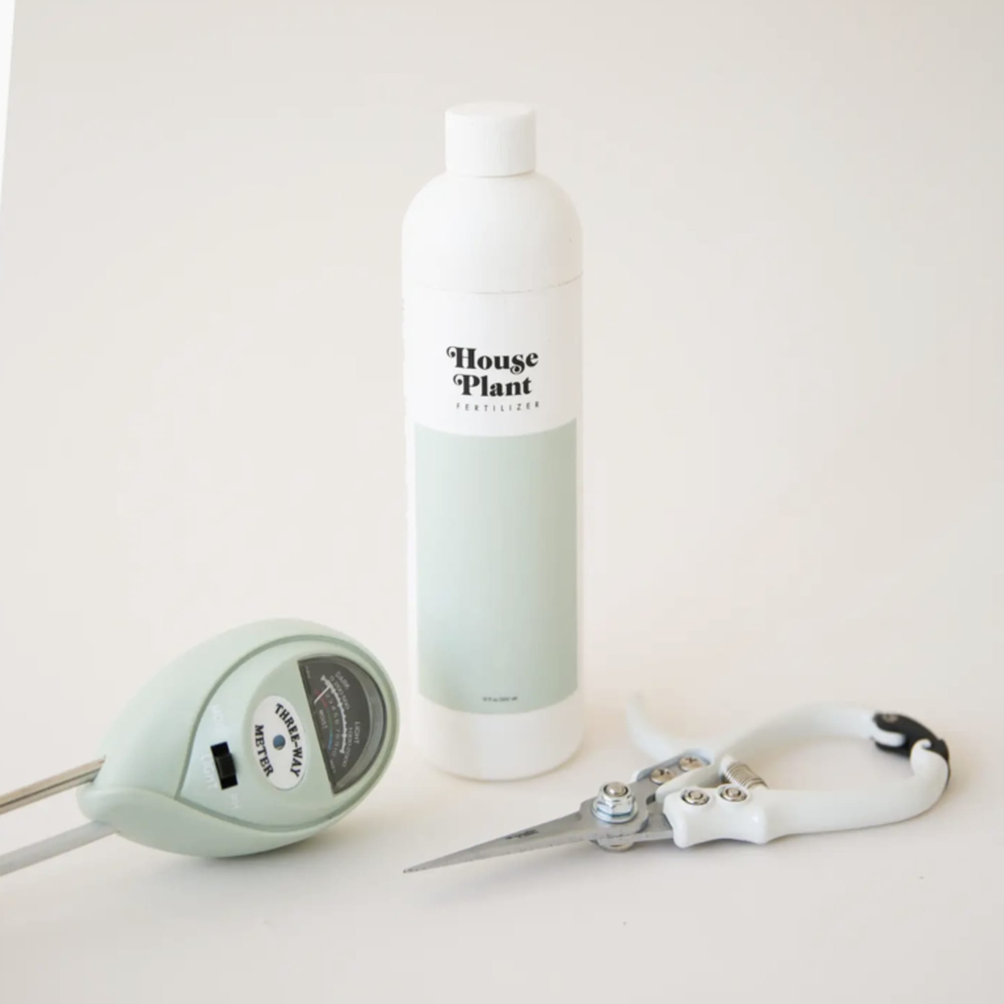 House Plant fertilizer bottle with a moisture meter and pruning shears