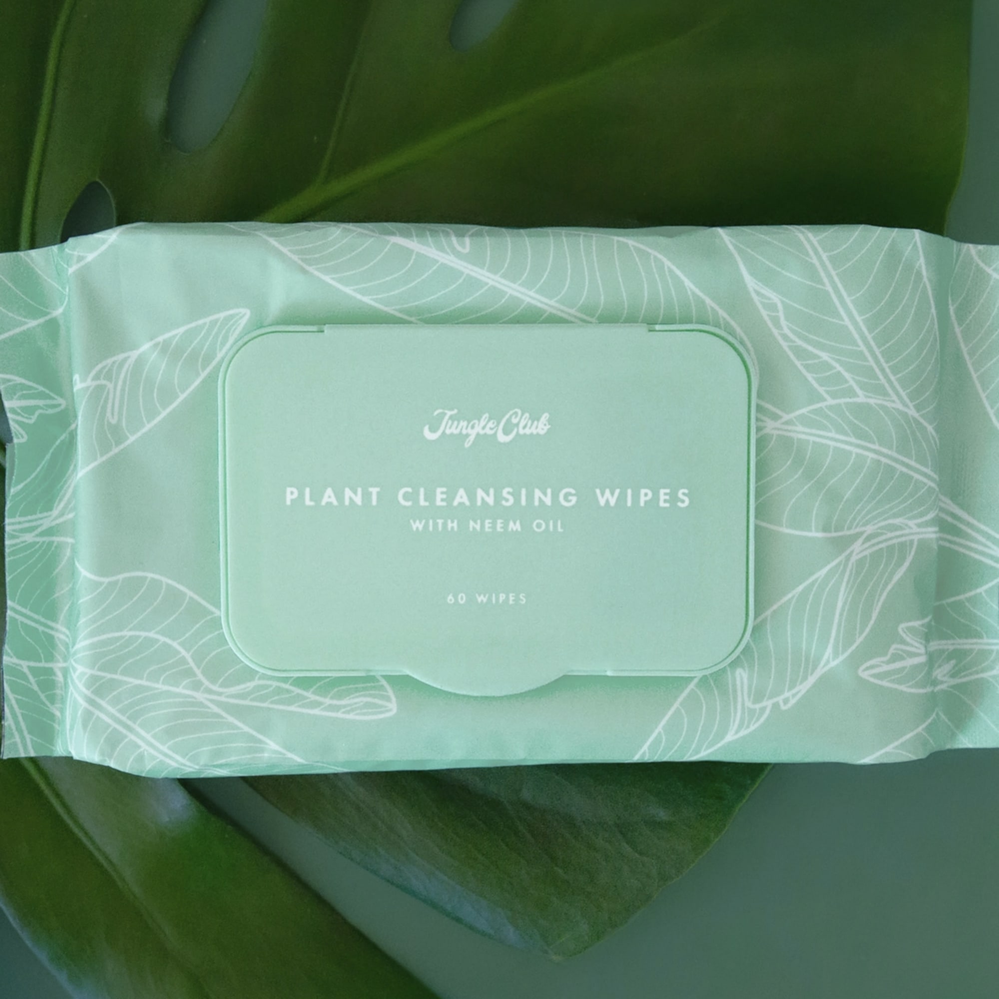 Pack of plant cleansing wipes on a green leaf background