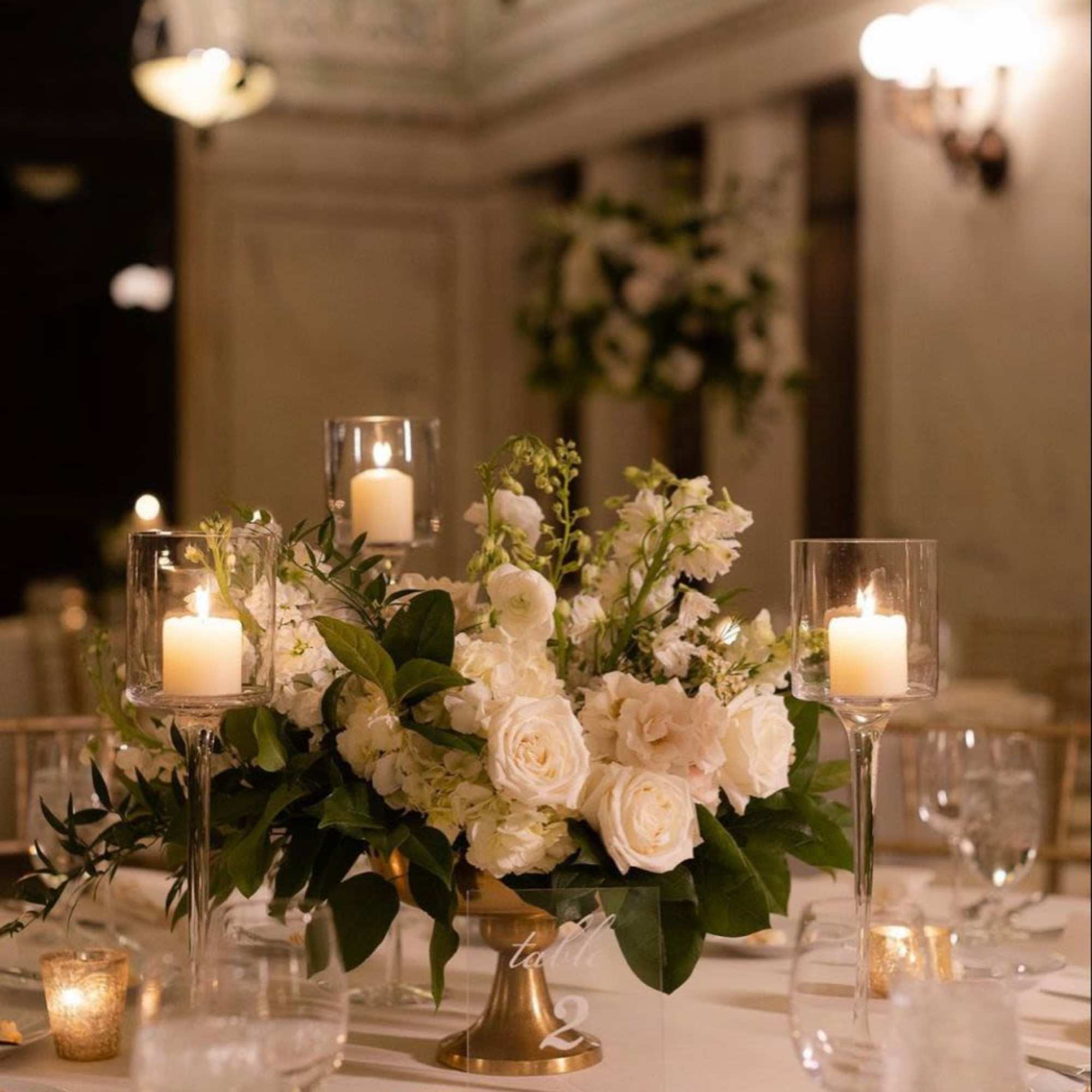 A low, classic wedding centerpiece designed to feel timeless, romantic, and guest-friendly