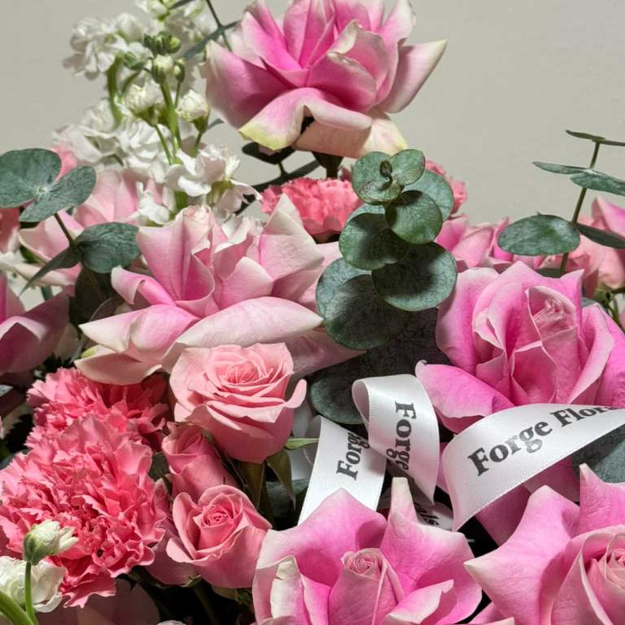 Fragrant eucalyptus with pink French roses in a cute pink hat box!