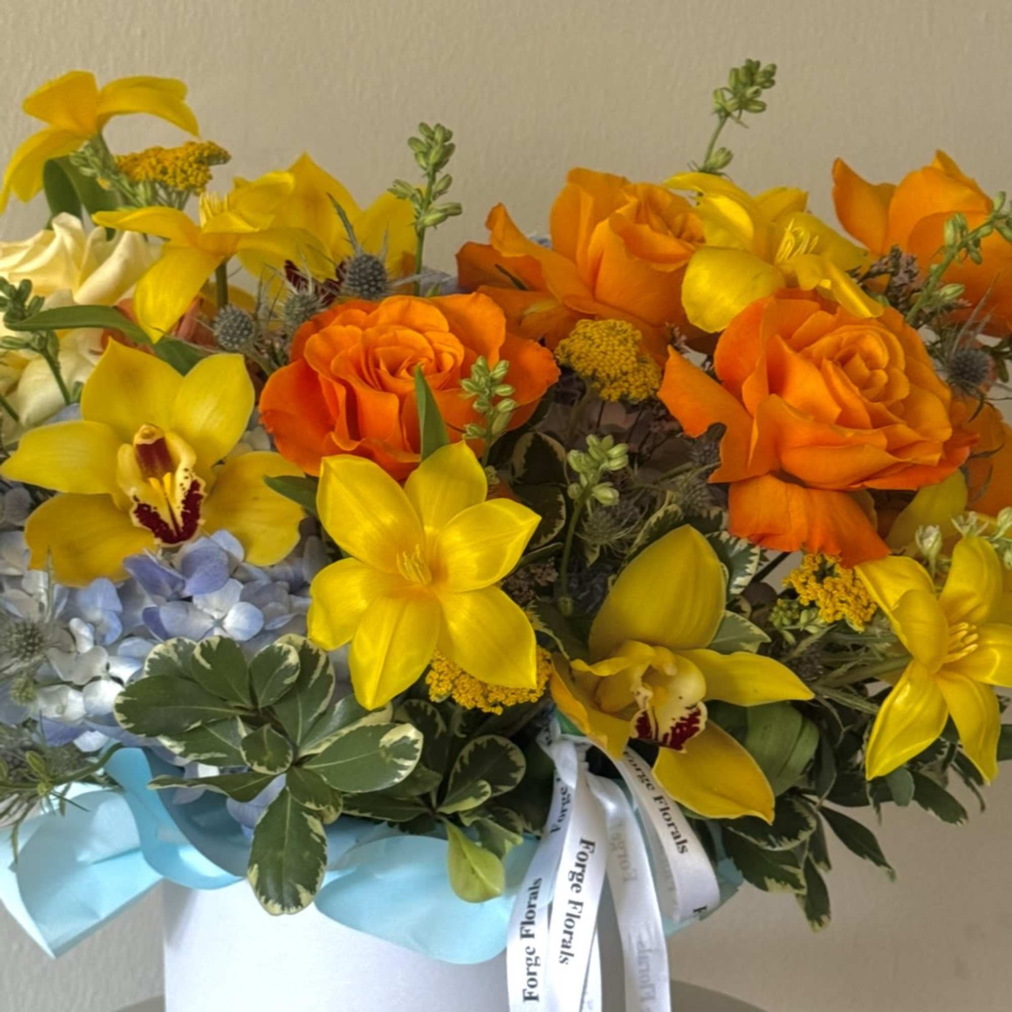 A vibrant and joyful design bursting with golden orchids, sunny tulips, bright