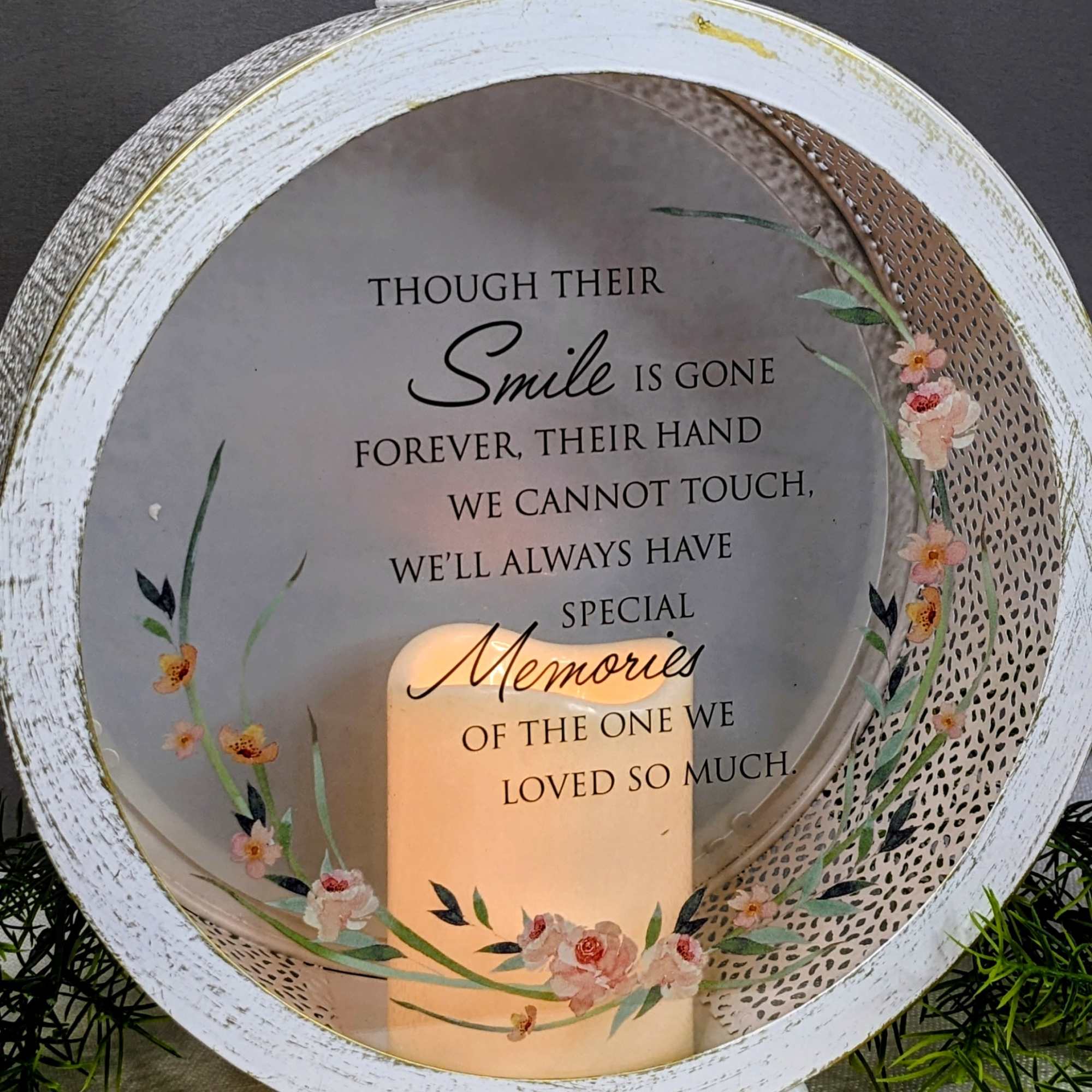 Round memorial lantern with a candle and sympathy quote