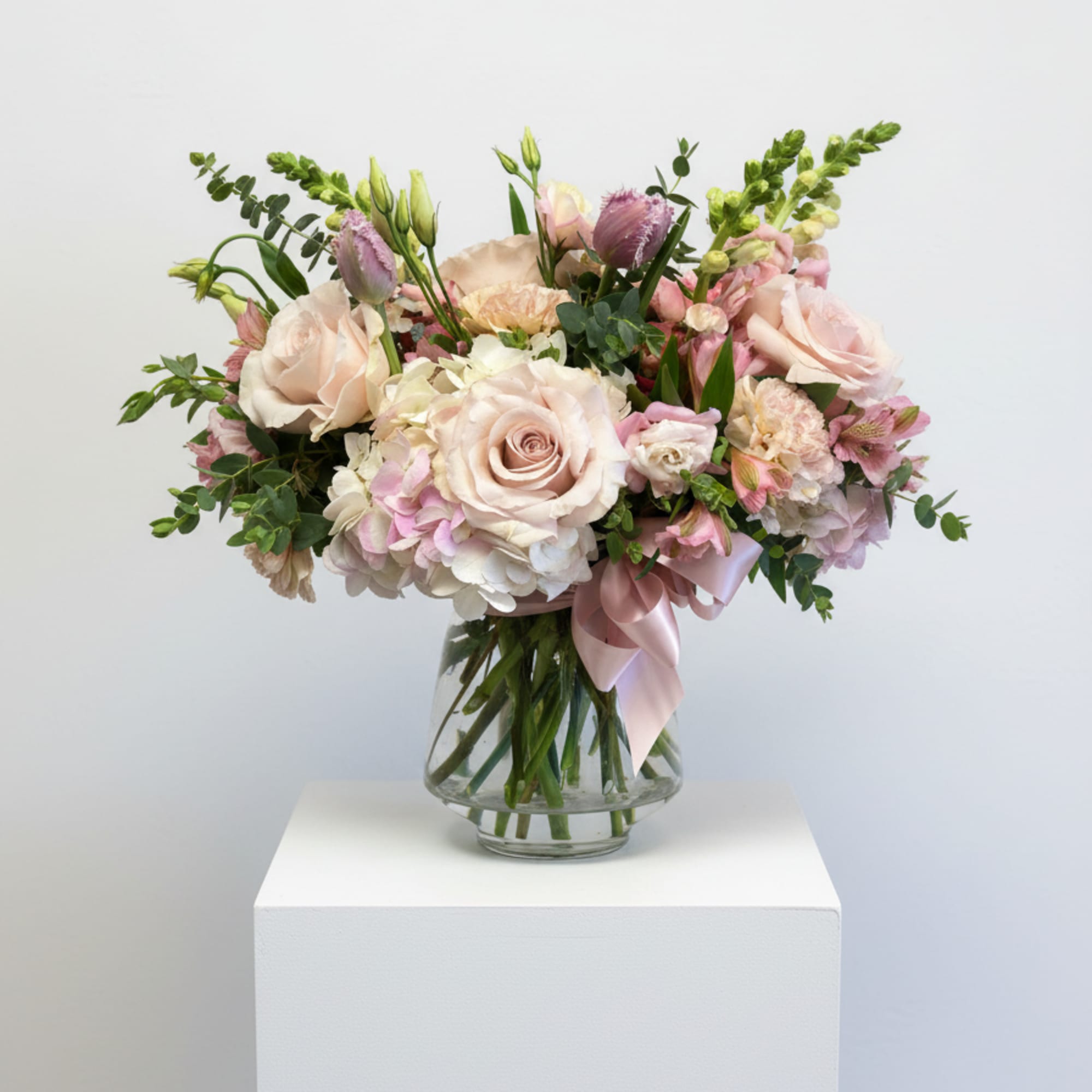 A lush cluster of soft white hydrangeas and pale pink roses creates, photo 2 of 3
