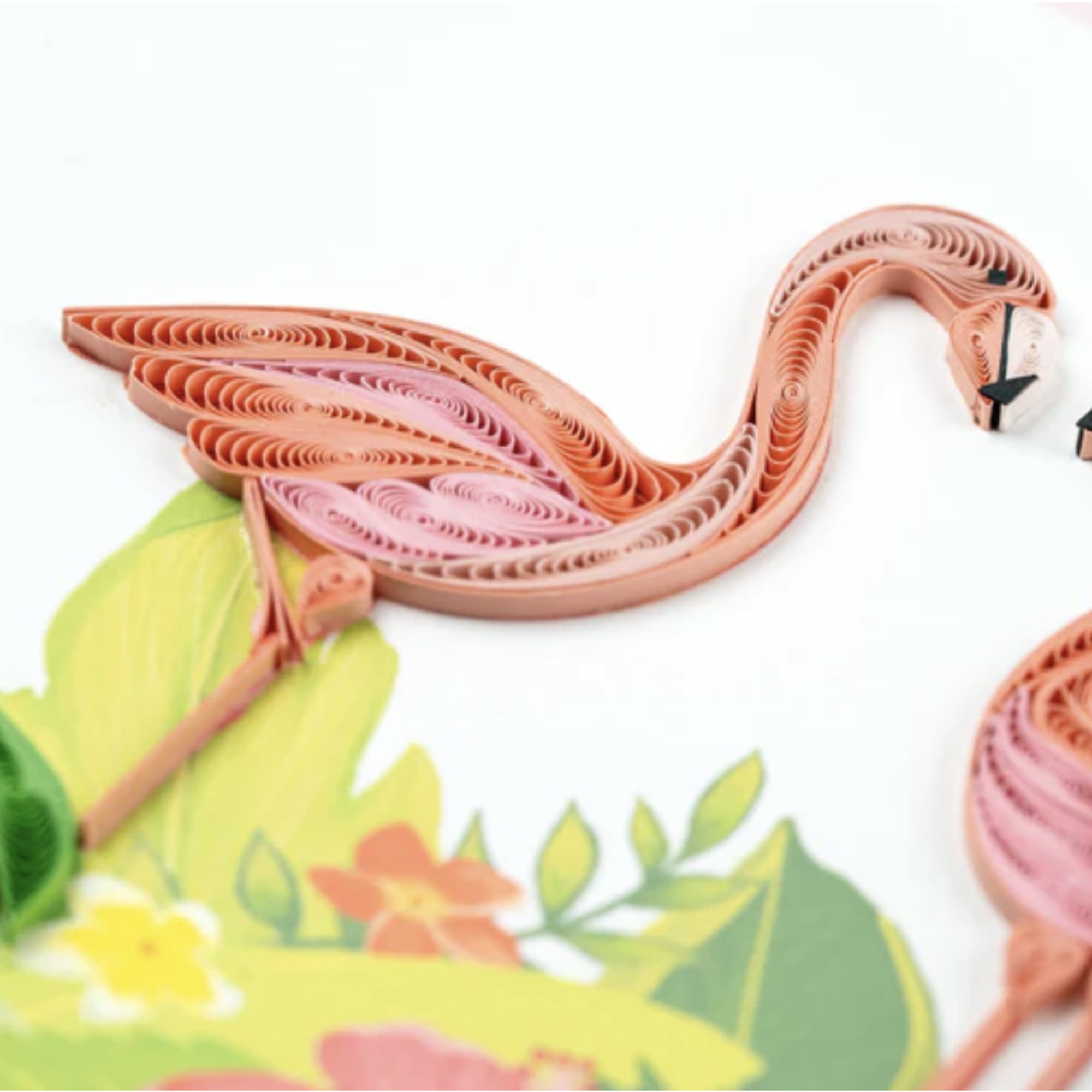 Paper quilled flamingo artwork with pink and peach birds on a floral background