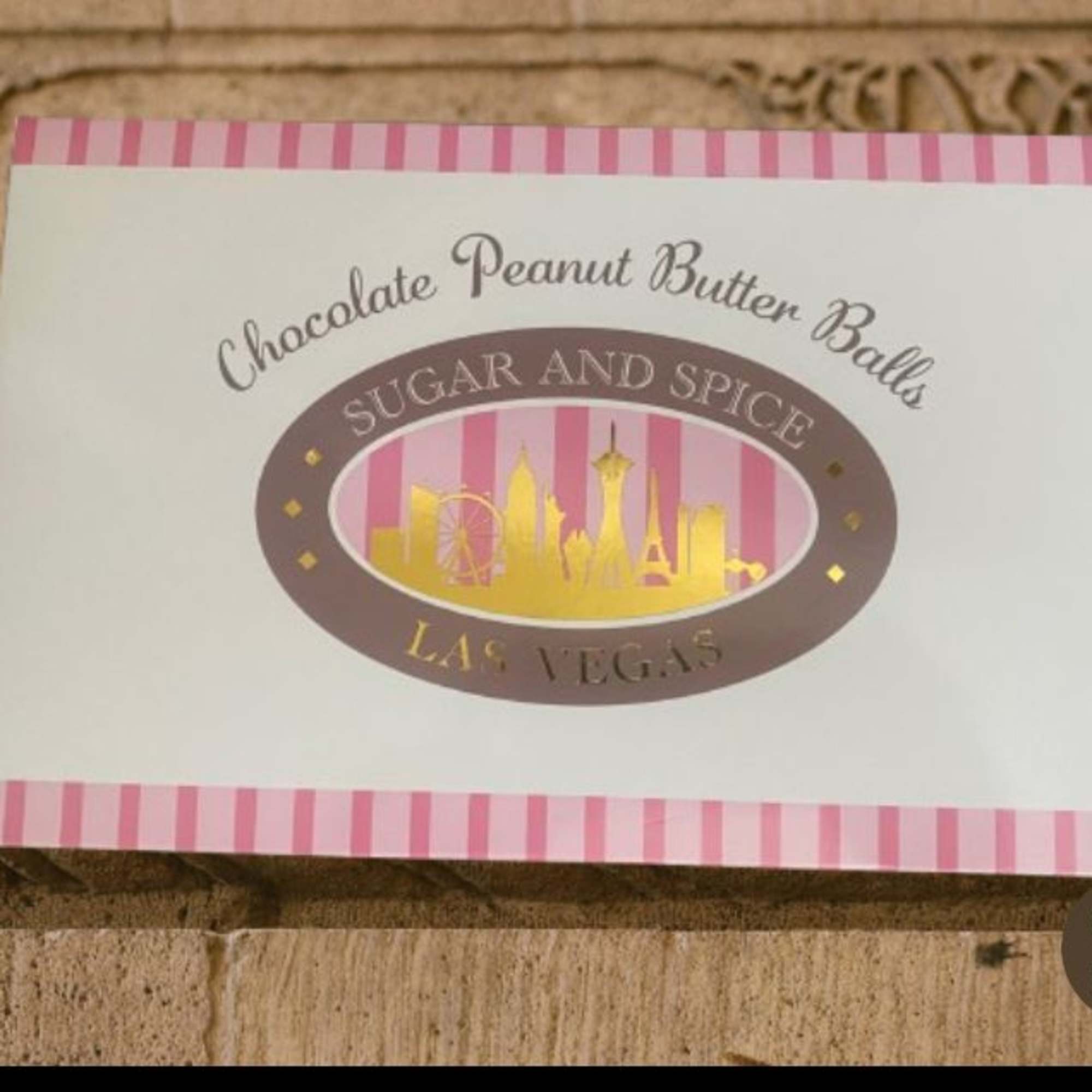 Candy label for chocolate peanut butter balls with pink stripes and Las Vegas skyline graphic