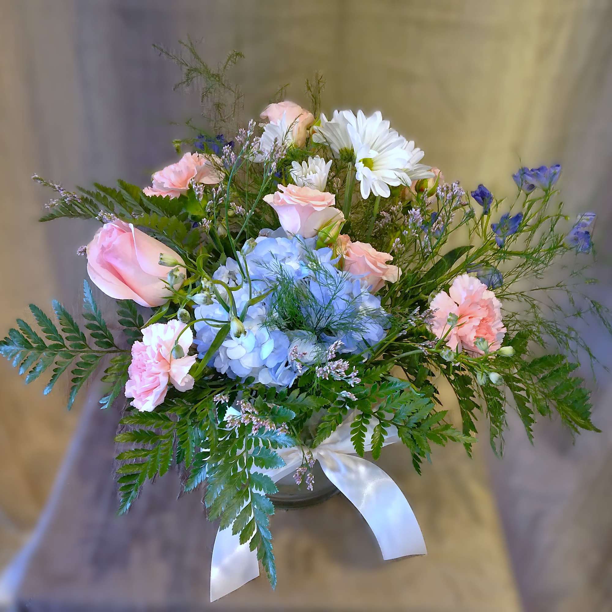 Lovely Lydia is a breathtaking symphony of peach and blue blossoms that