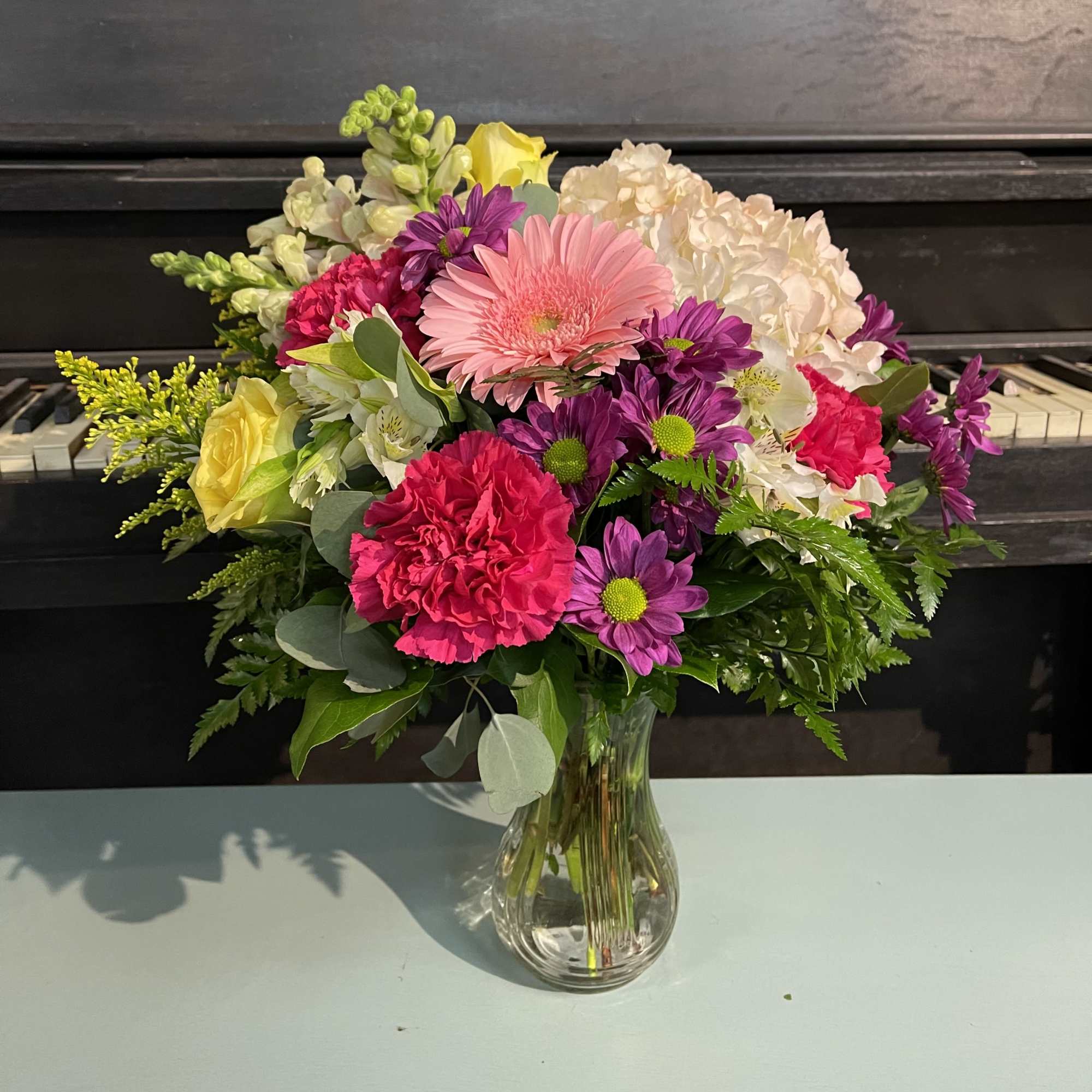 A beautiful mixture of the freshest flower in a vase. A bright