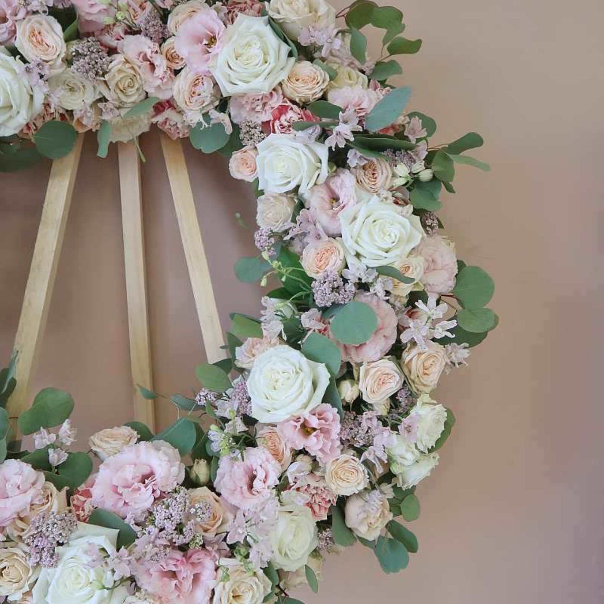 Large pastel floral wreath with white and pink roses