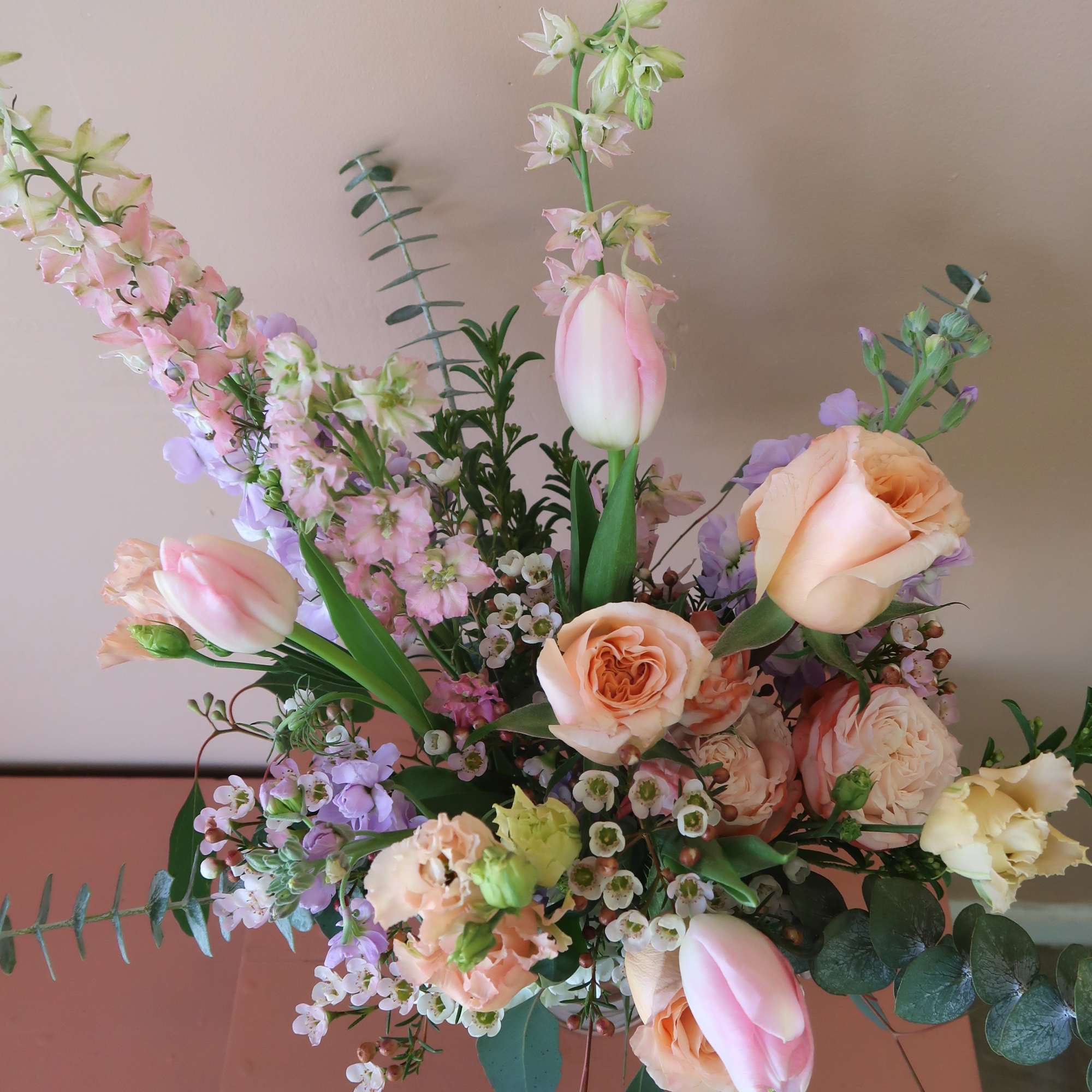 Pastel bouquet with pink tulips, peach roses, and lavender flowers