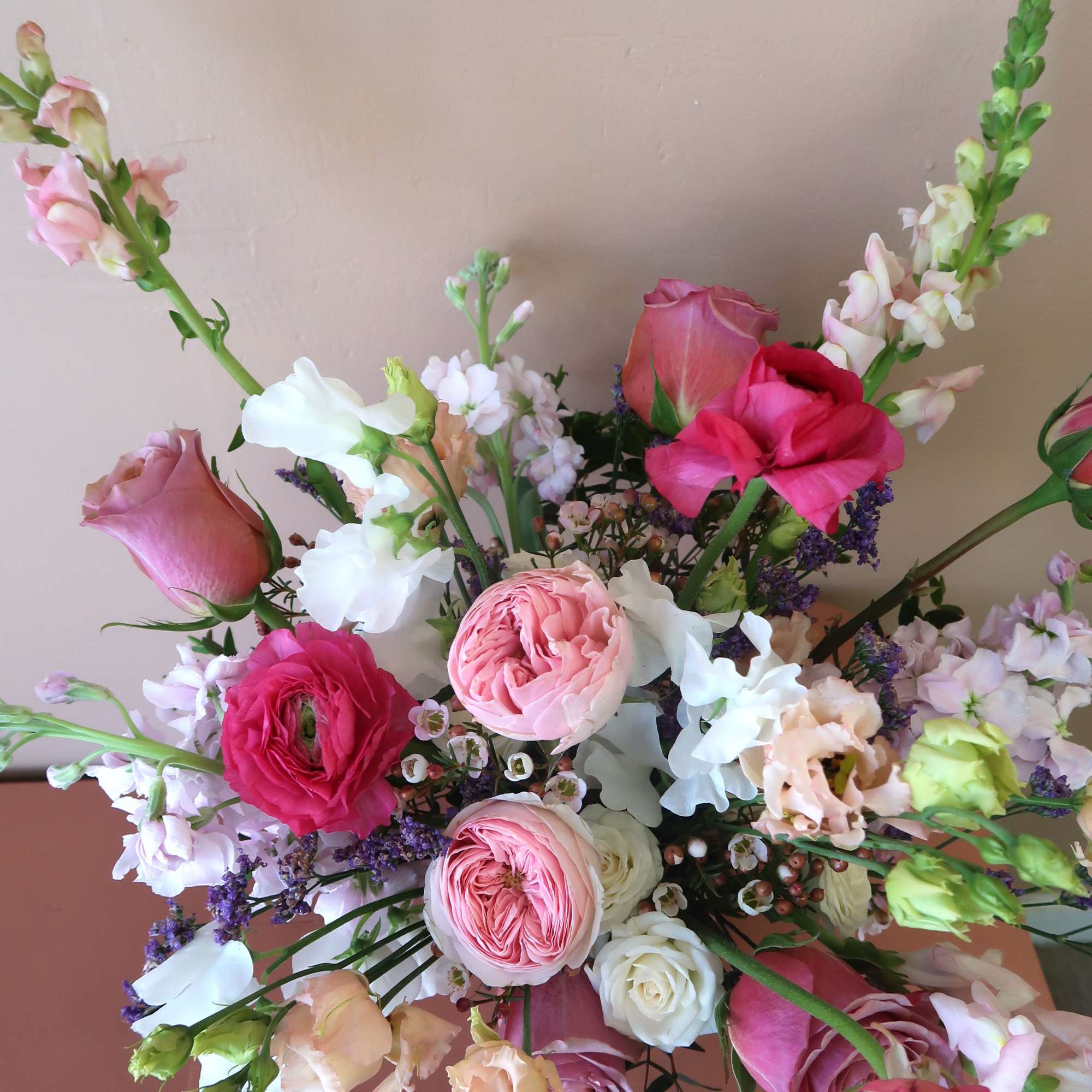 Mixed bouquet of pink, white, and peach flowers with tall stems