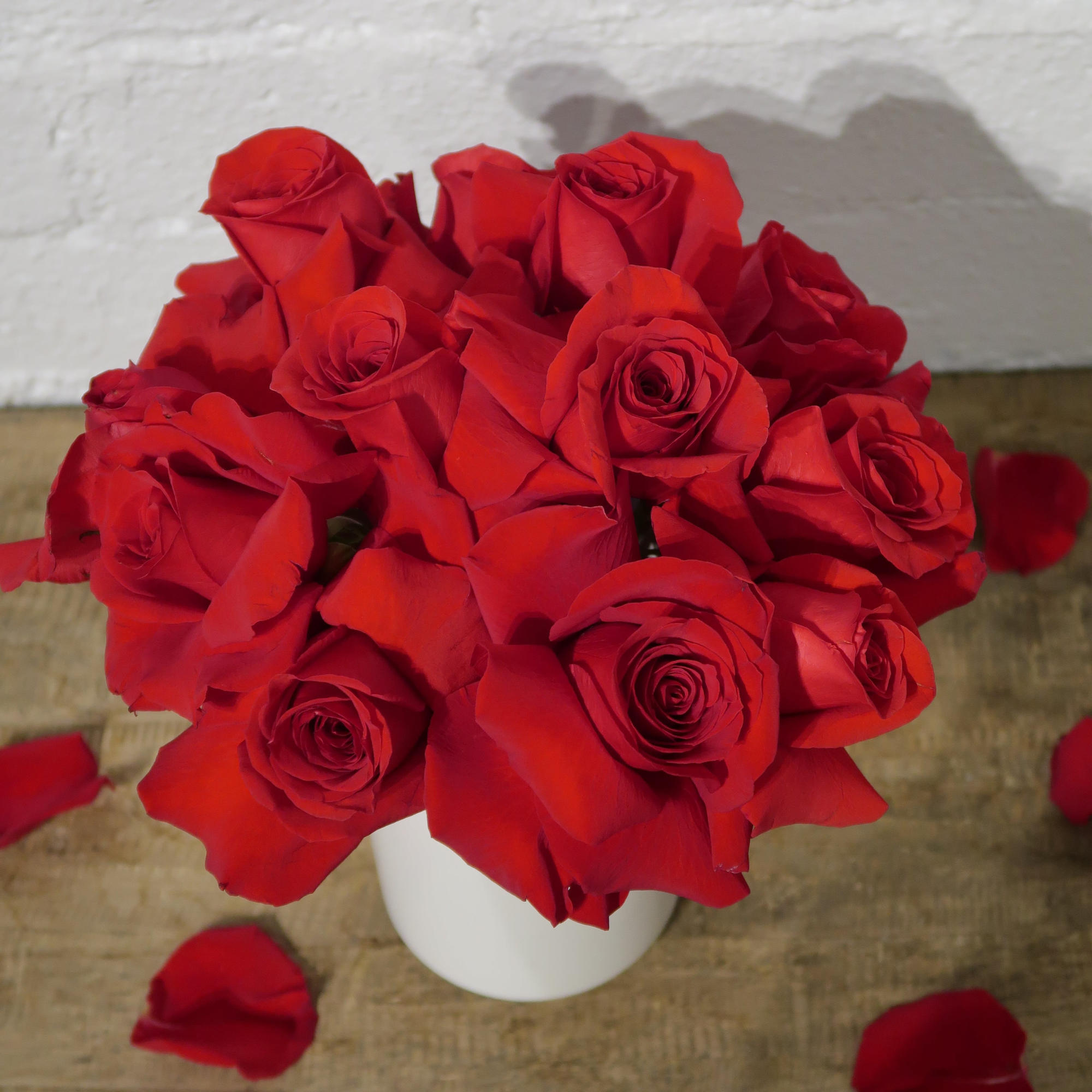 Bouquet of red roses in a white vase