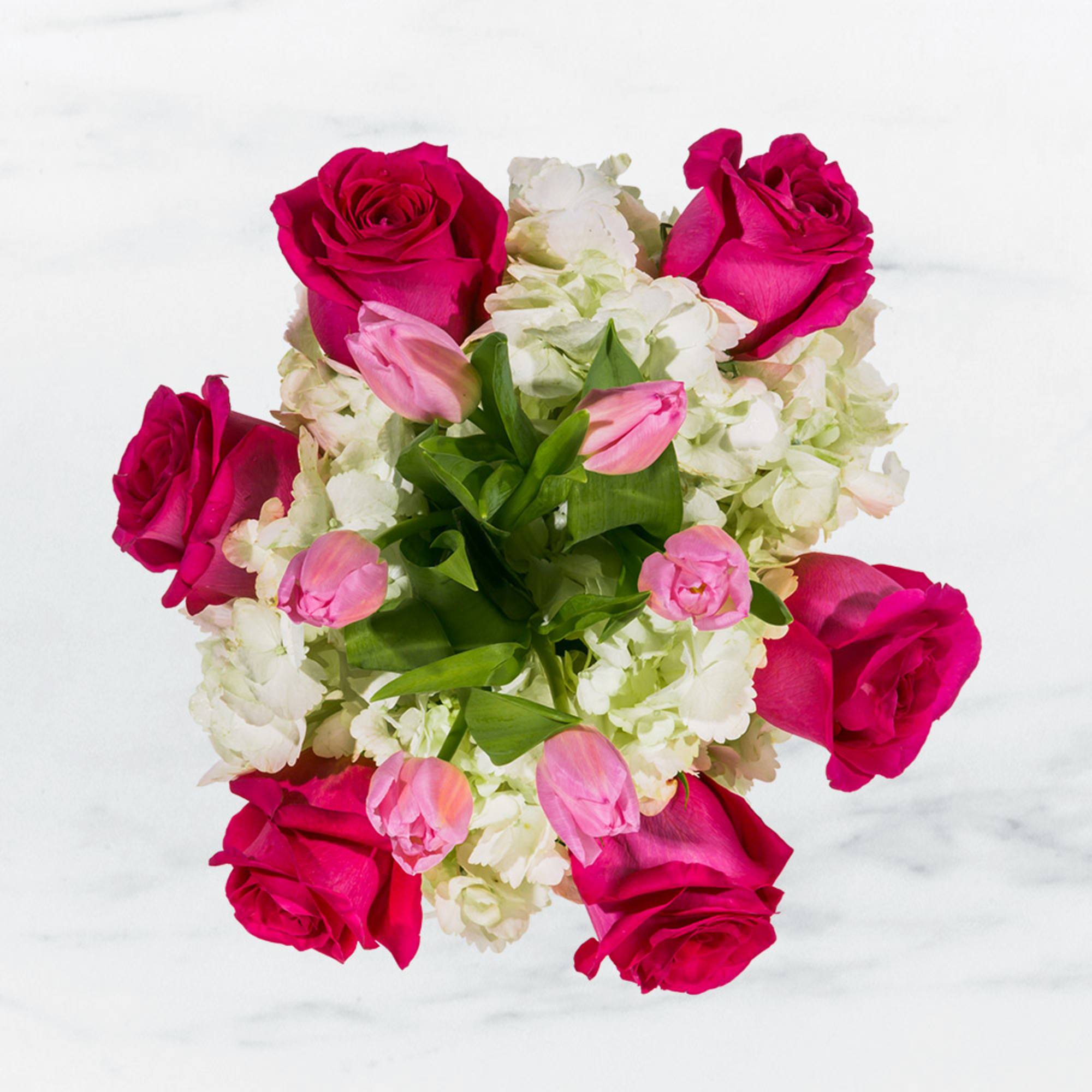 Bouquet of hot pink roses, white hydrangeas, and pink tulips