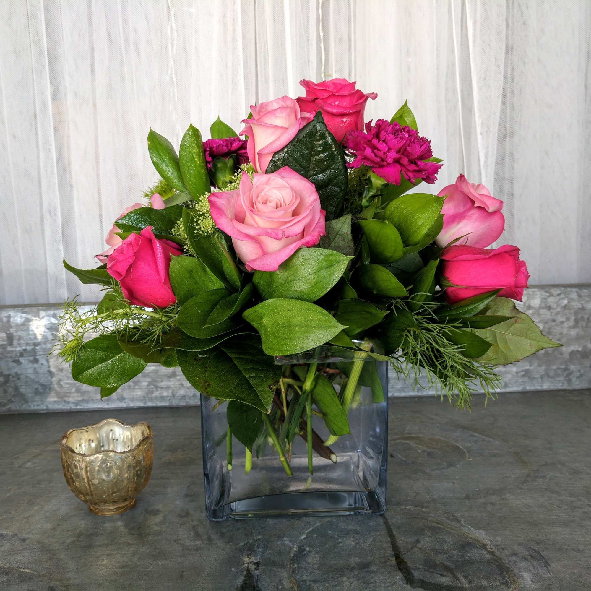 A beautiful cube filled with pink Roses, Moon Vista Carnations and adorned