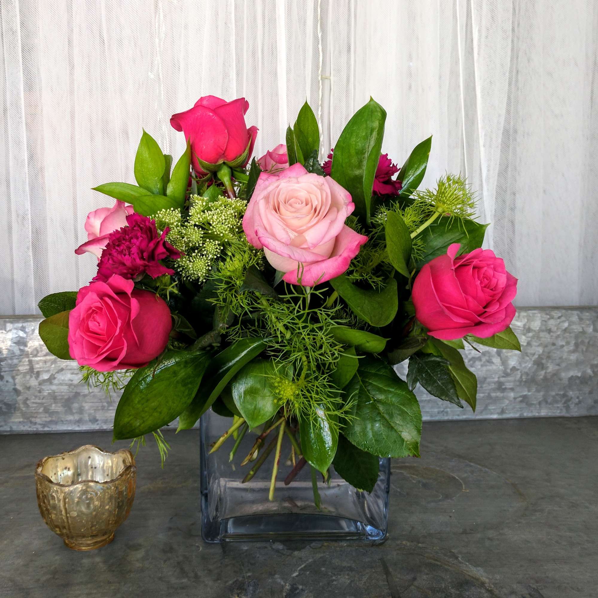 A beautiful cube filled with pink Roses, Moon Vista Carnations and adorned