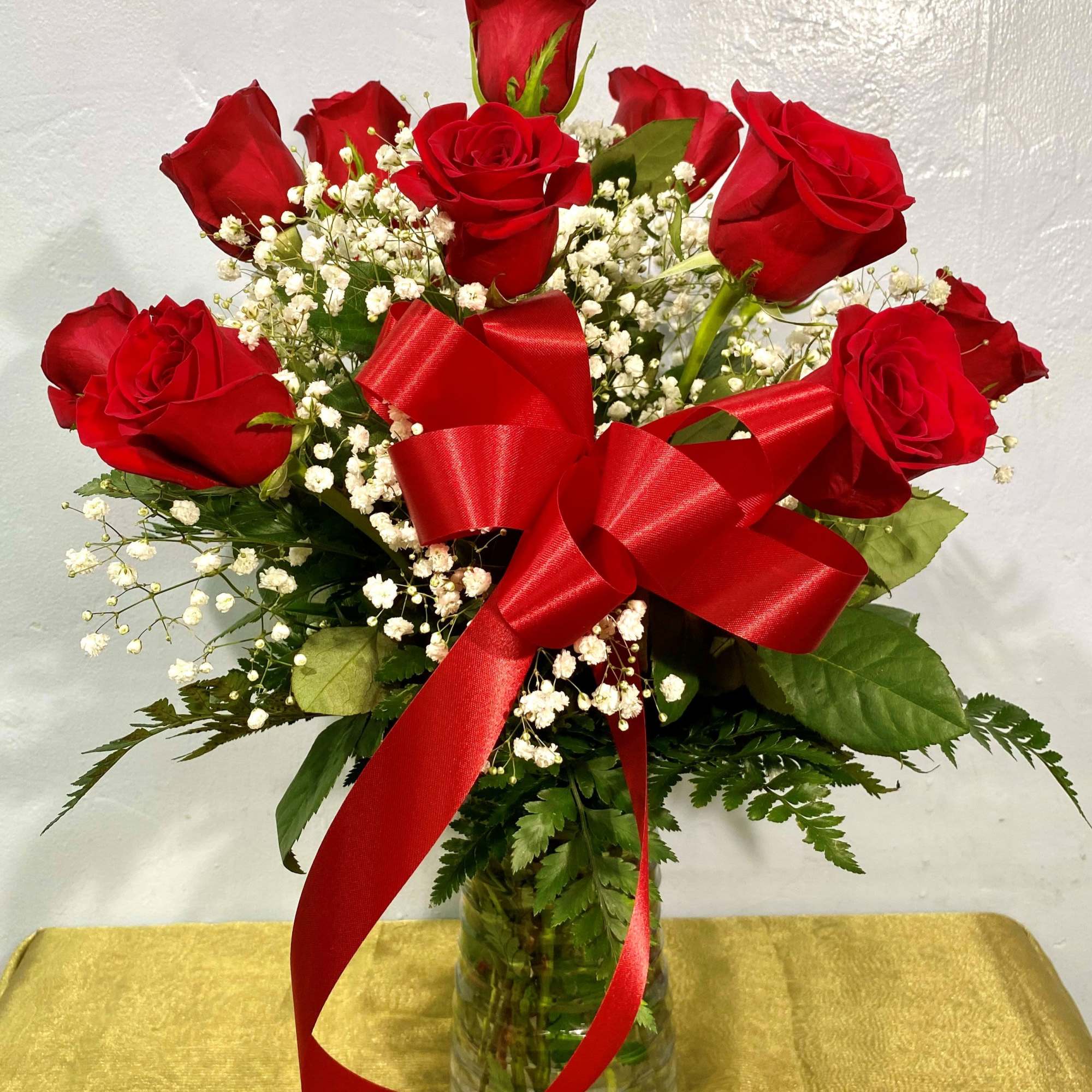 Vivid red long-stemmed roses gathered with cloud-like white baby's breath create a, photo 2 of 2