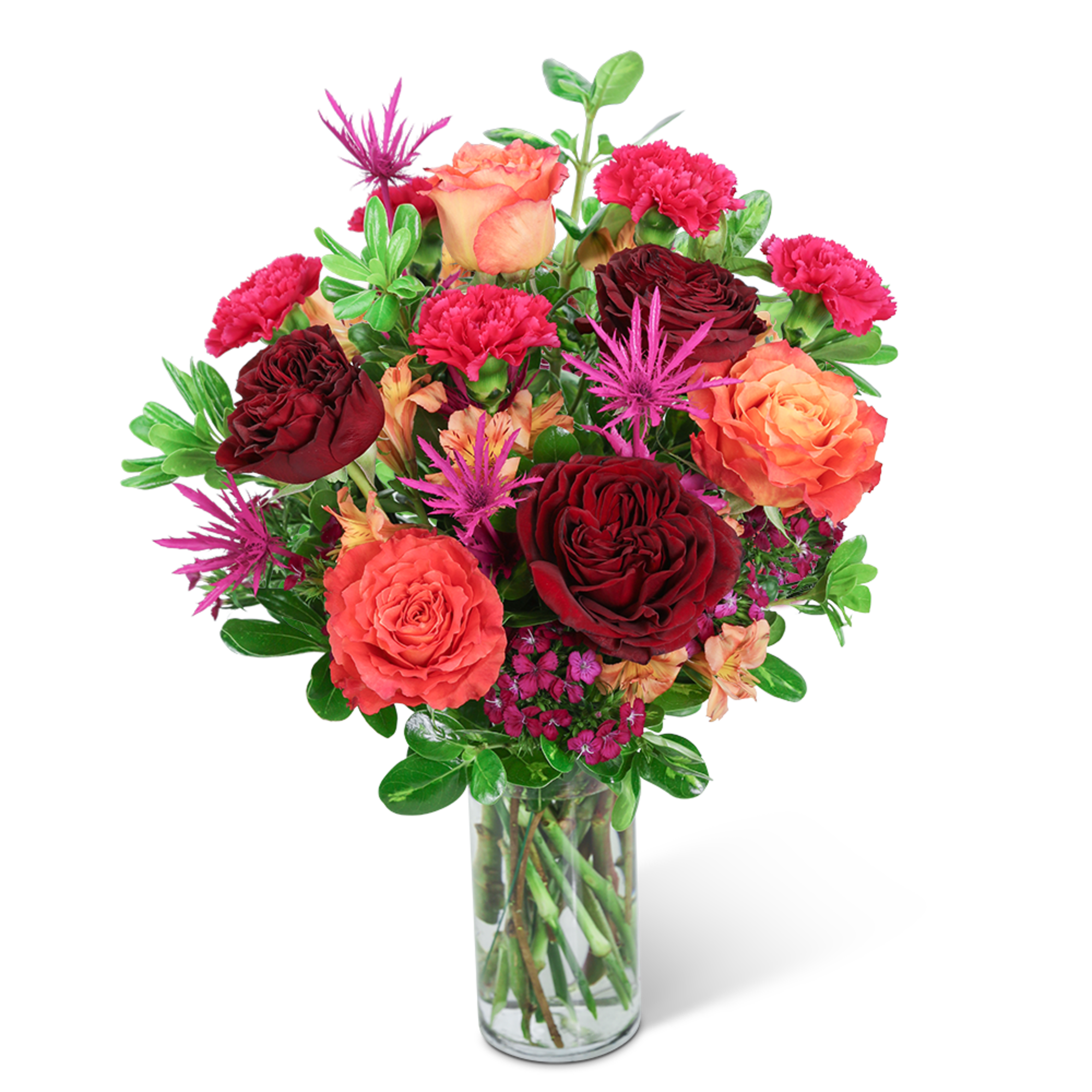 Bouquet of red and orange roses with pink carnations in a glass vase