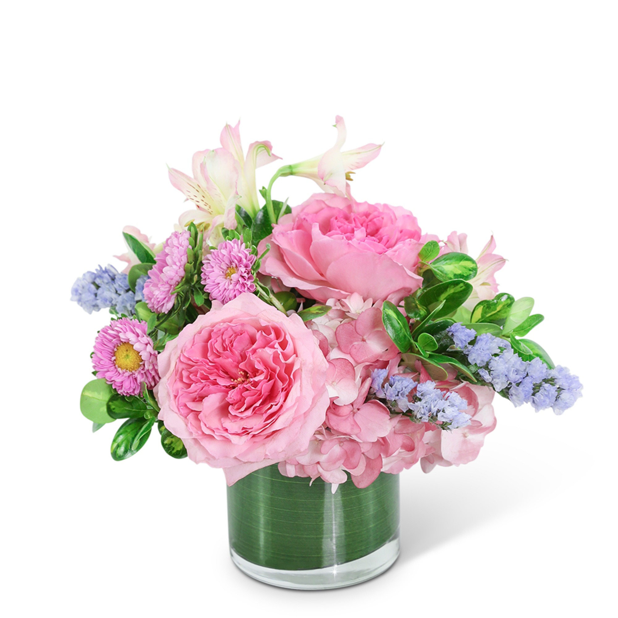 Pink floral arrangement in a clear glass vase with lavender accents
