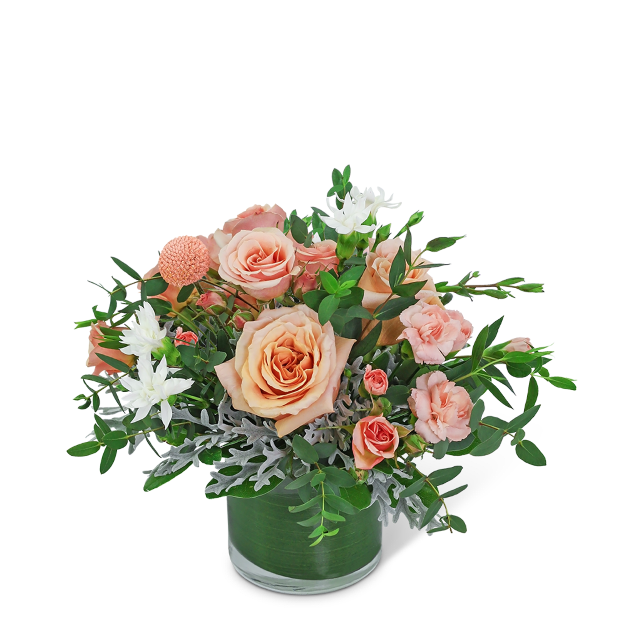 Peach roses and white flowers in a green glass vase