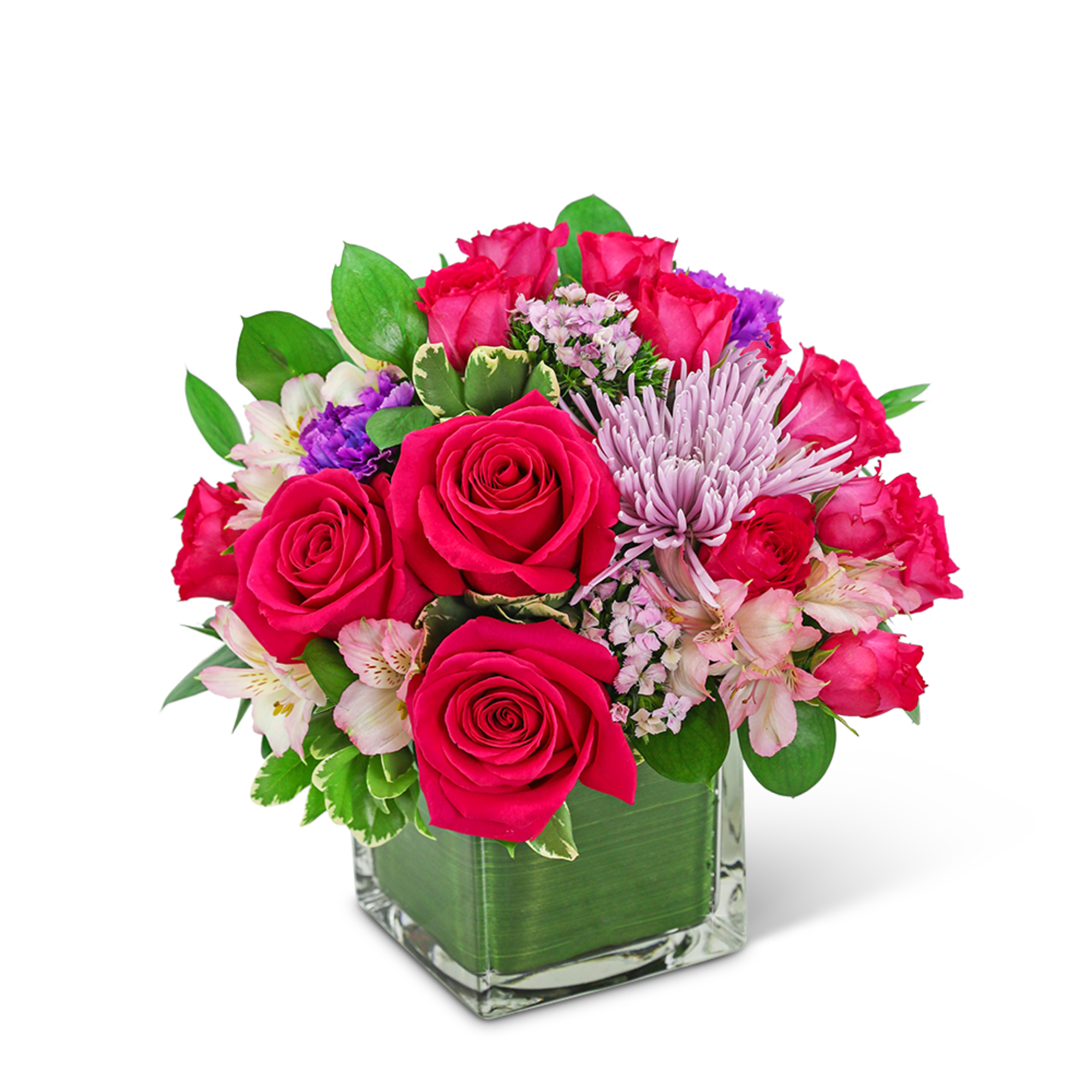 Pink roses and mixed blooms arranged in a square glass vase