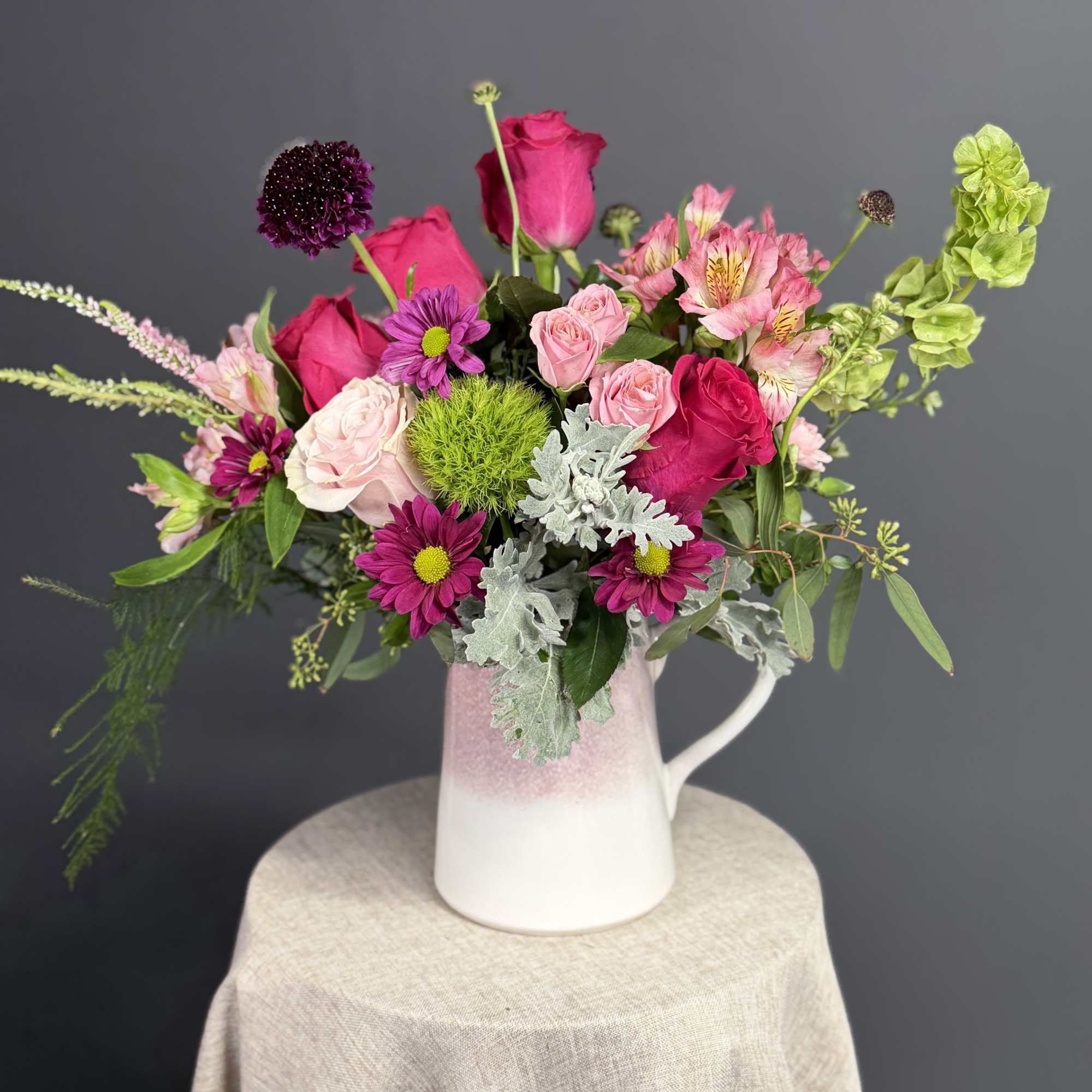 Capturing the untamed beauty of a wild meadow, this vibrant arrangement is