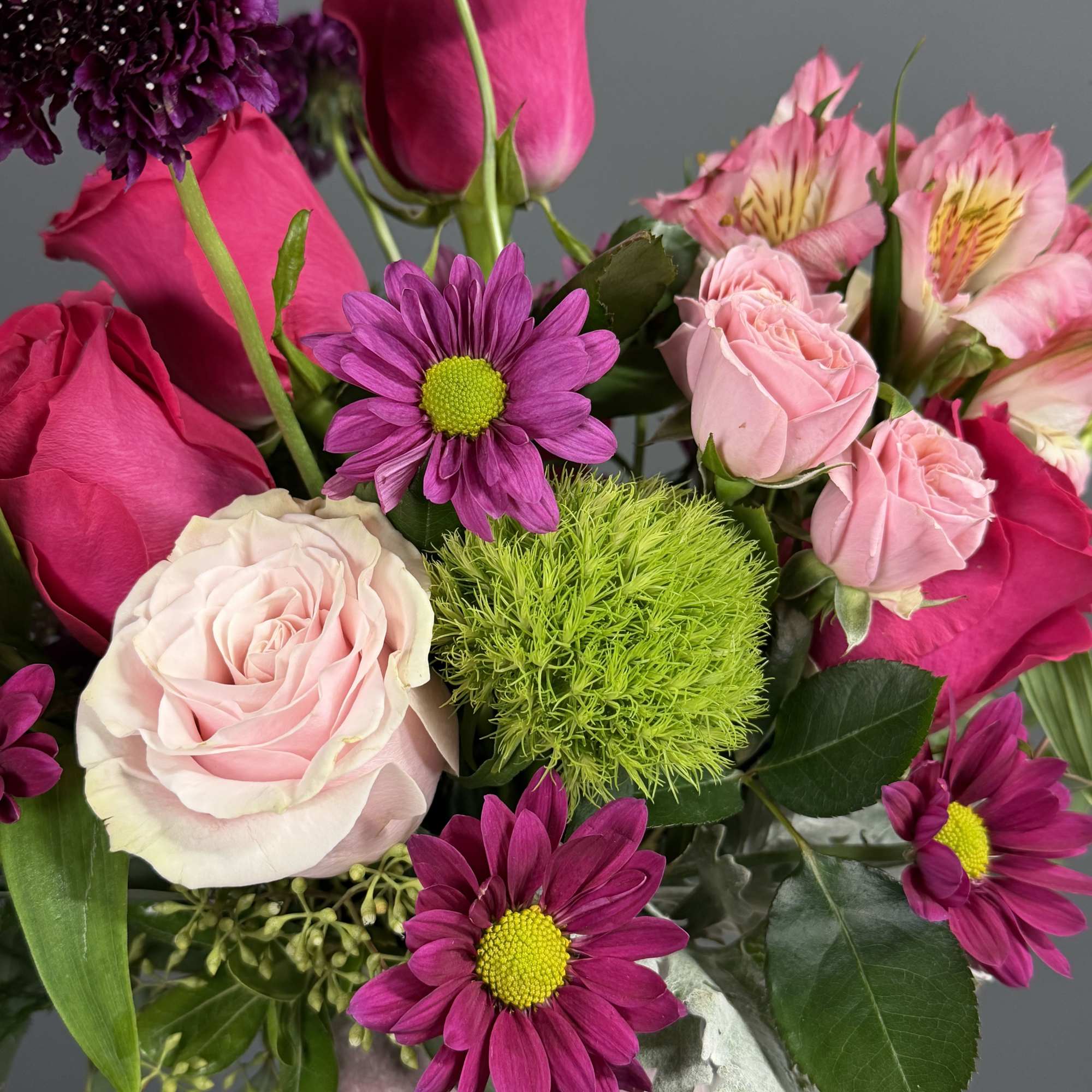 Capturing the untamed beauty of a wild meadow, this vibrant arrangement is