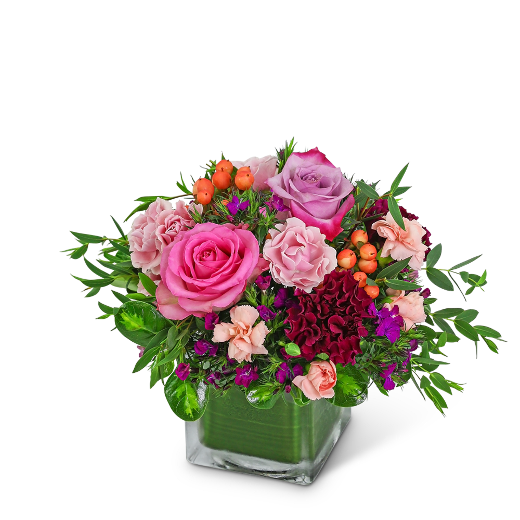 Pink and purple rose arrangement in a square glass vase