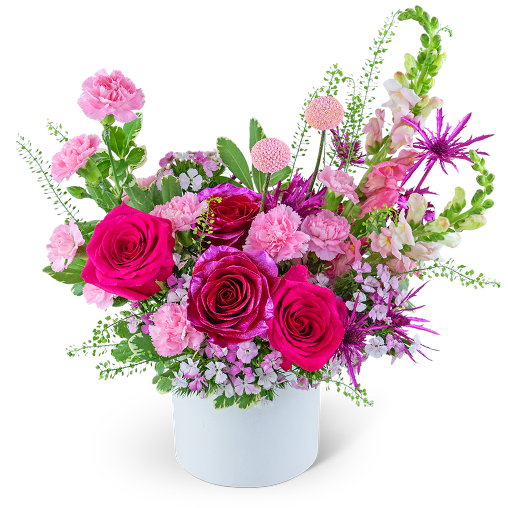 Pink and magenta roses in a white vase with mixed filler flowers