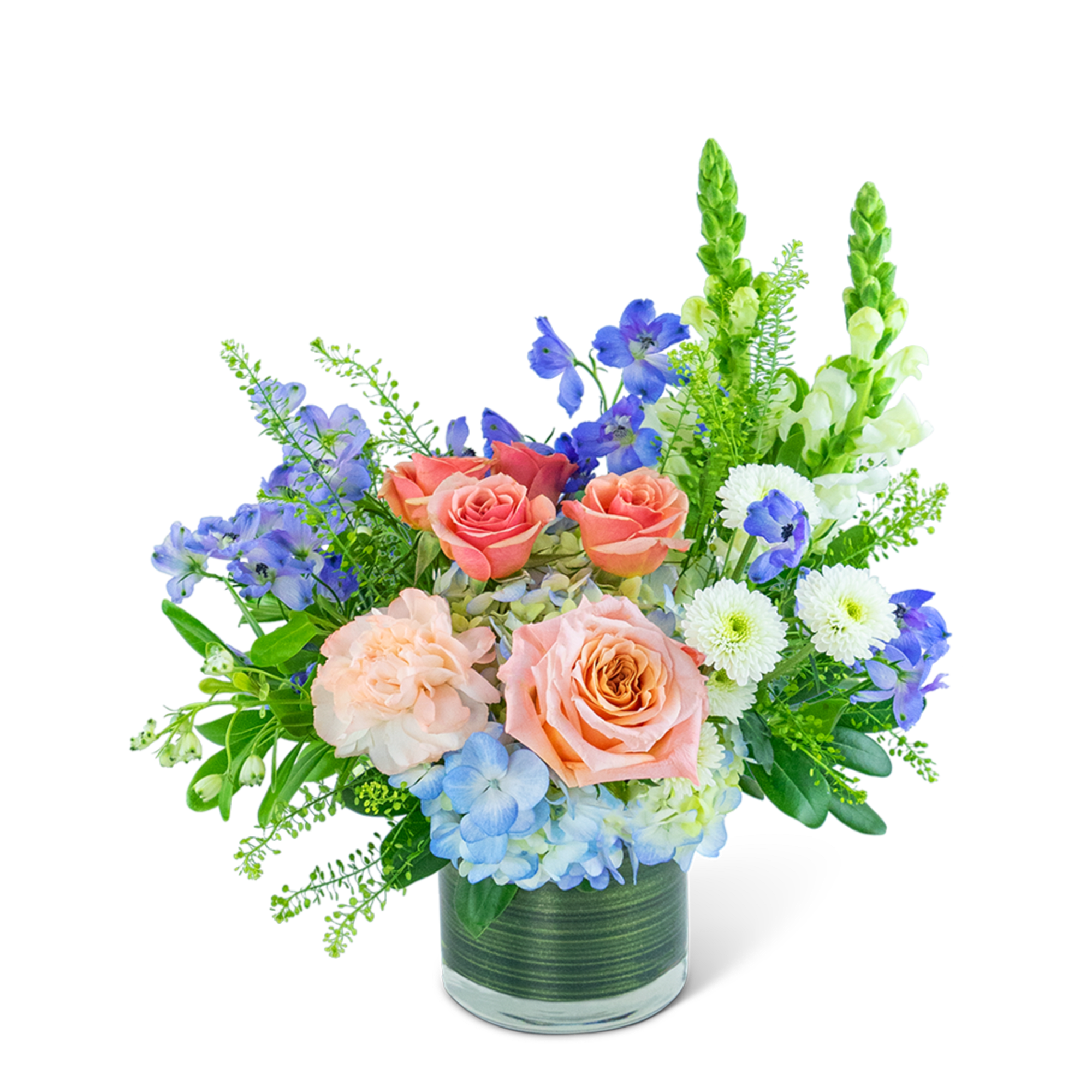 Mixed bouquet of peach roses, blue flowers, and white blooms in a glass vase