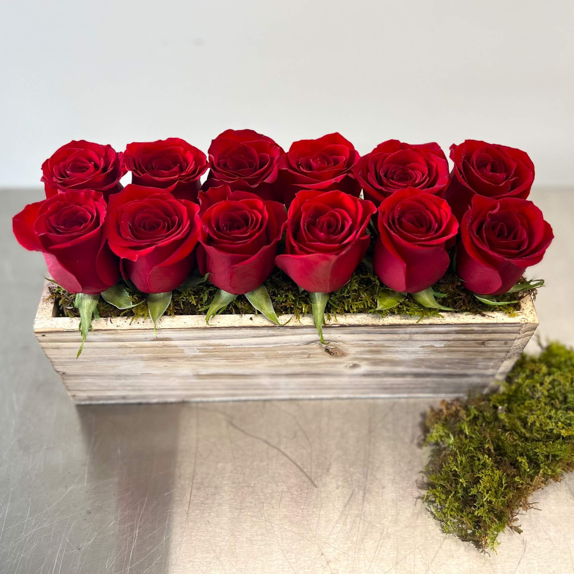 Red roses arranged in a rectangular wooden box