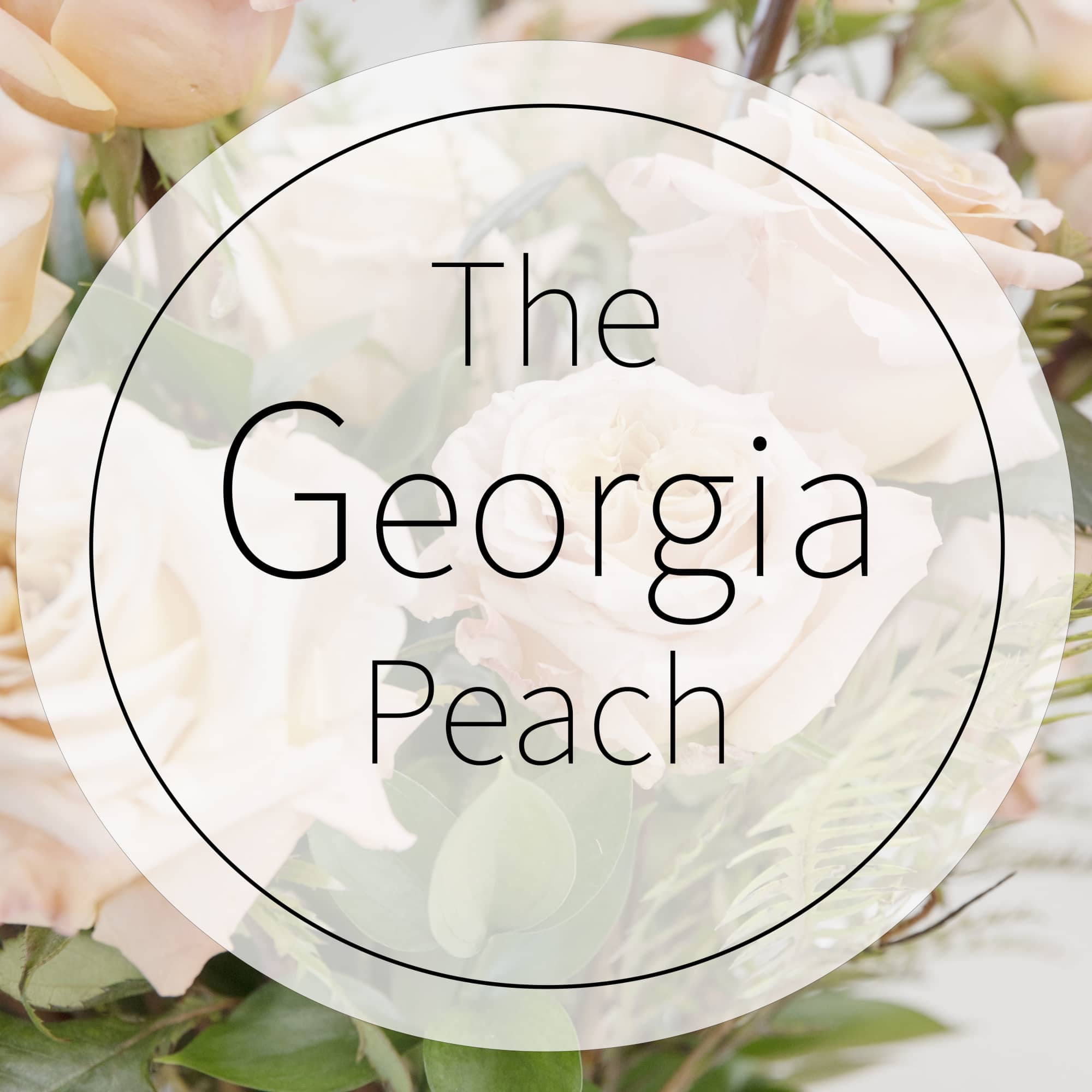 Peach and white roses with greenery behind a circular logo