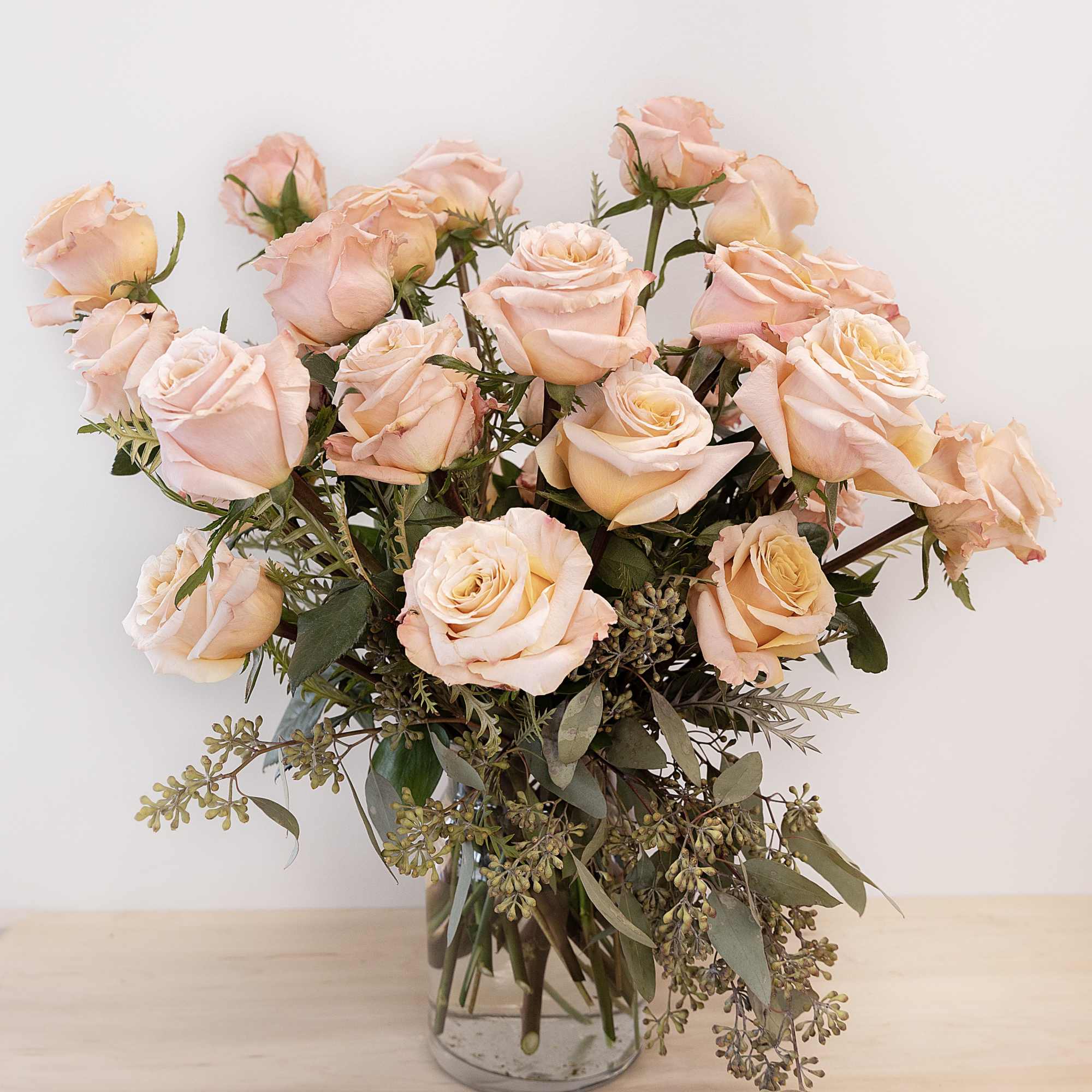 Blush peach rose bouquet in a clear glass vase