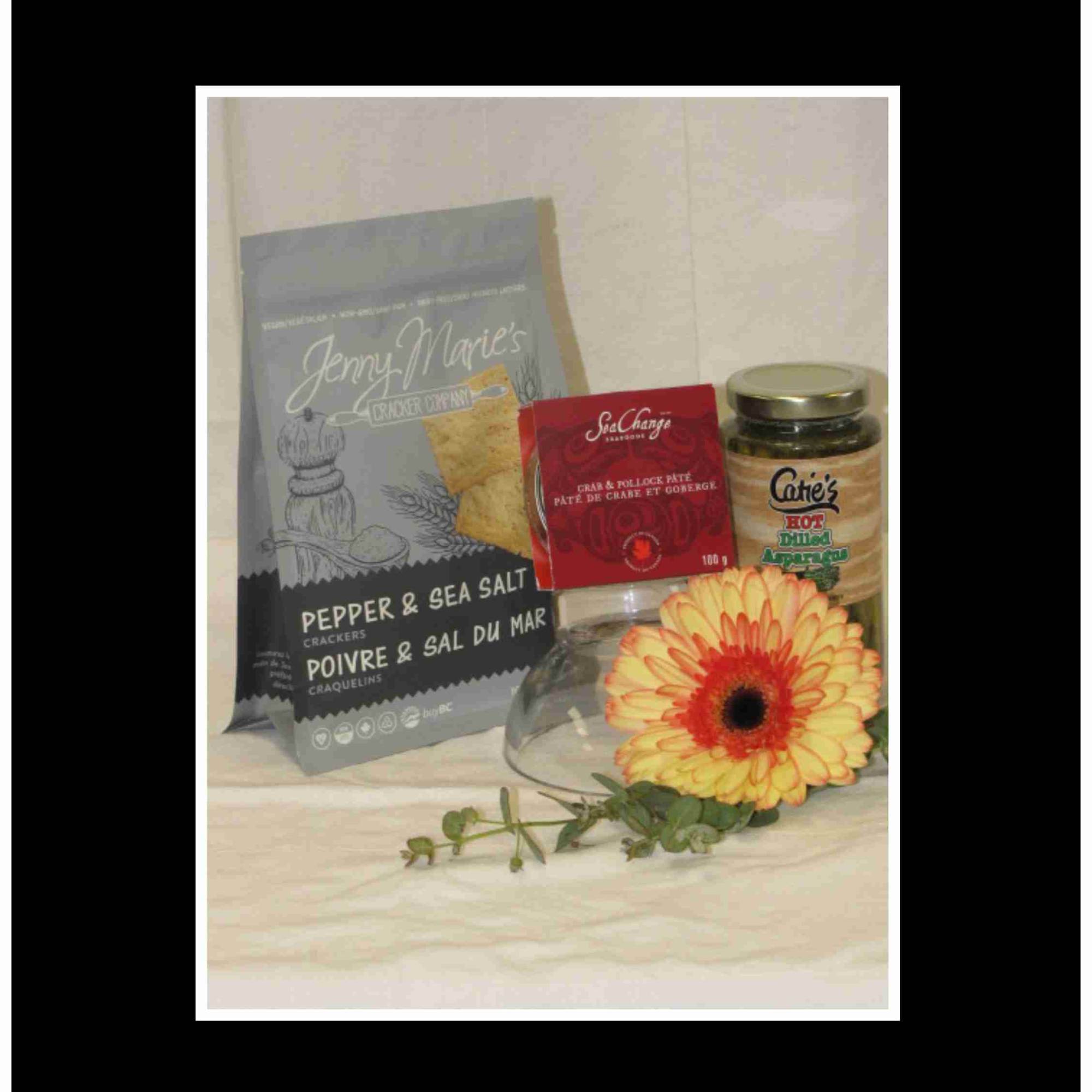 Gift basket with crackers, pate, asparagus, and a yellow gerbera daisy