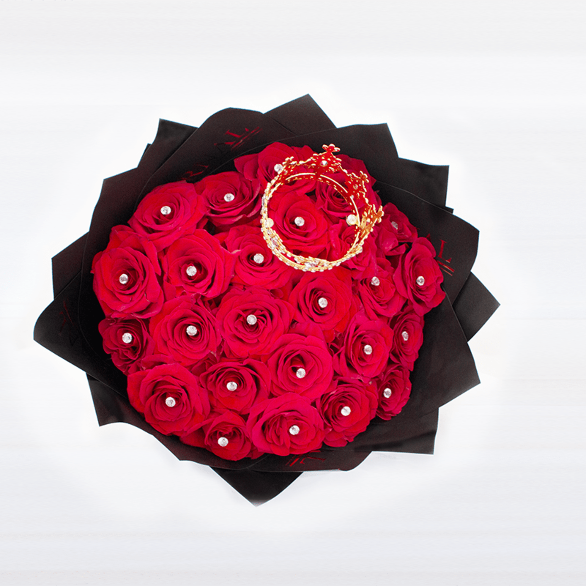 Round bouquet of red roses with pearl accents wrapped in black paper