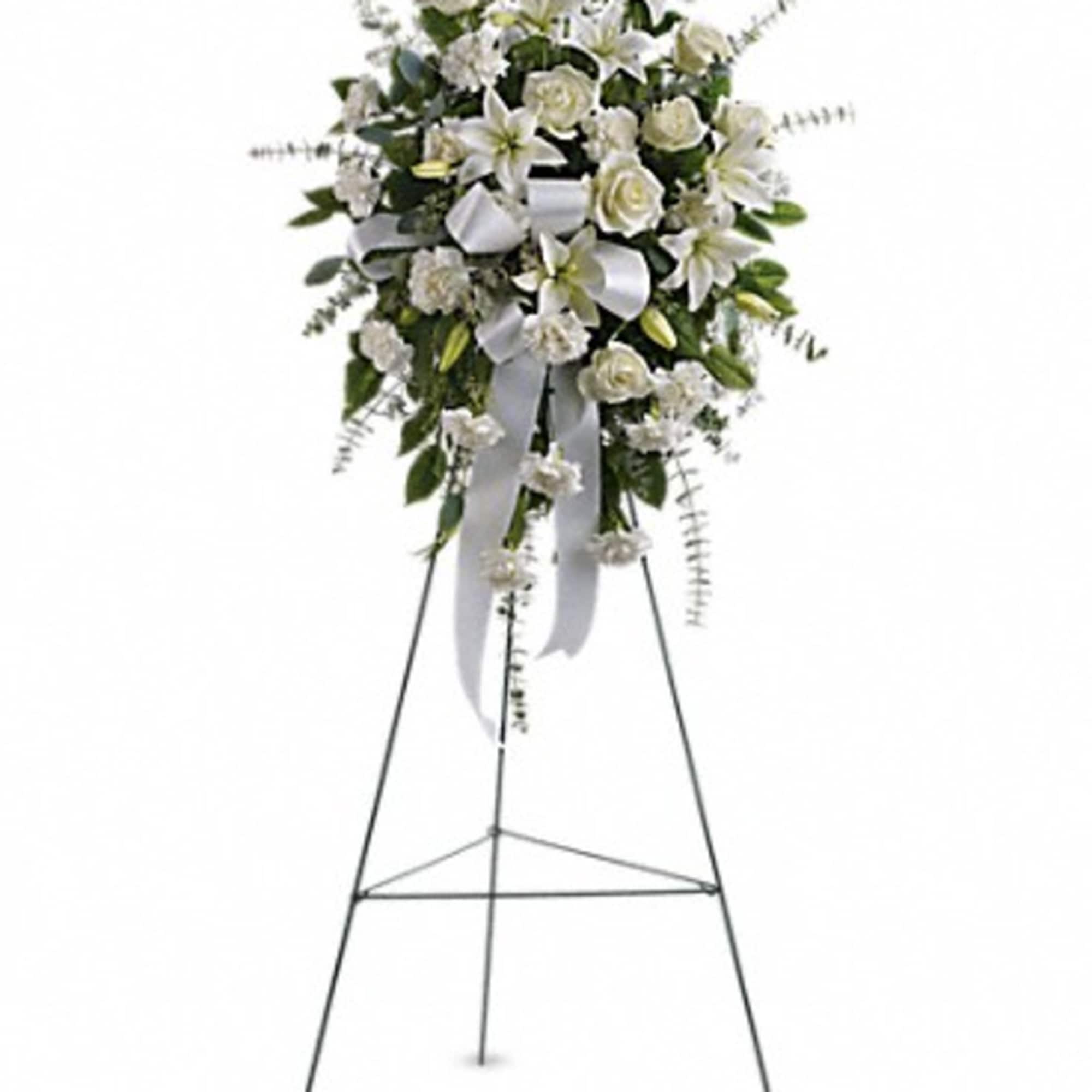 White funeral spray on a standing easel with ribbon