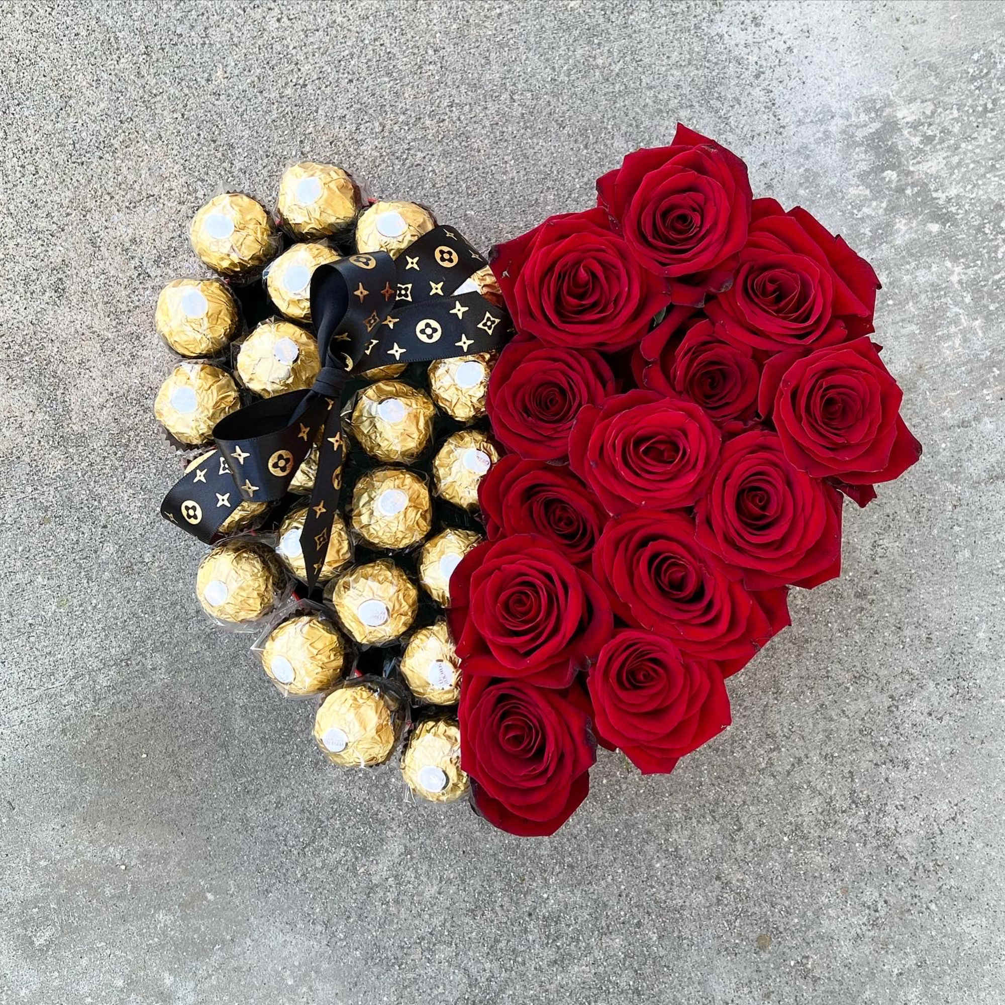 Fresh red roses and chocolate in a heart box (black or red