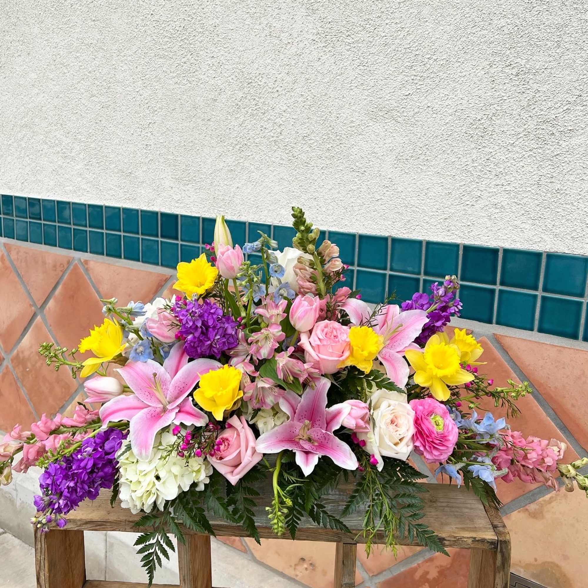 Colorful mixed bouquet with pink lilies, roses, and yellow blooms