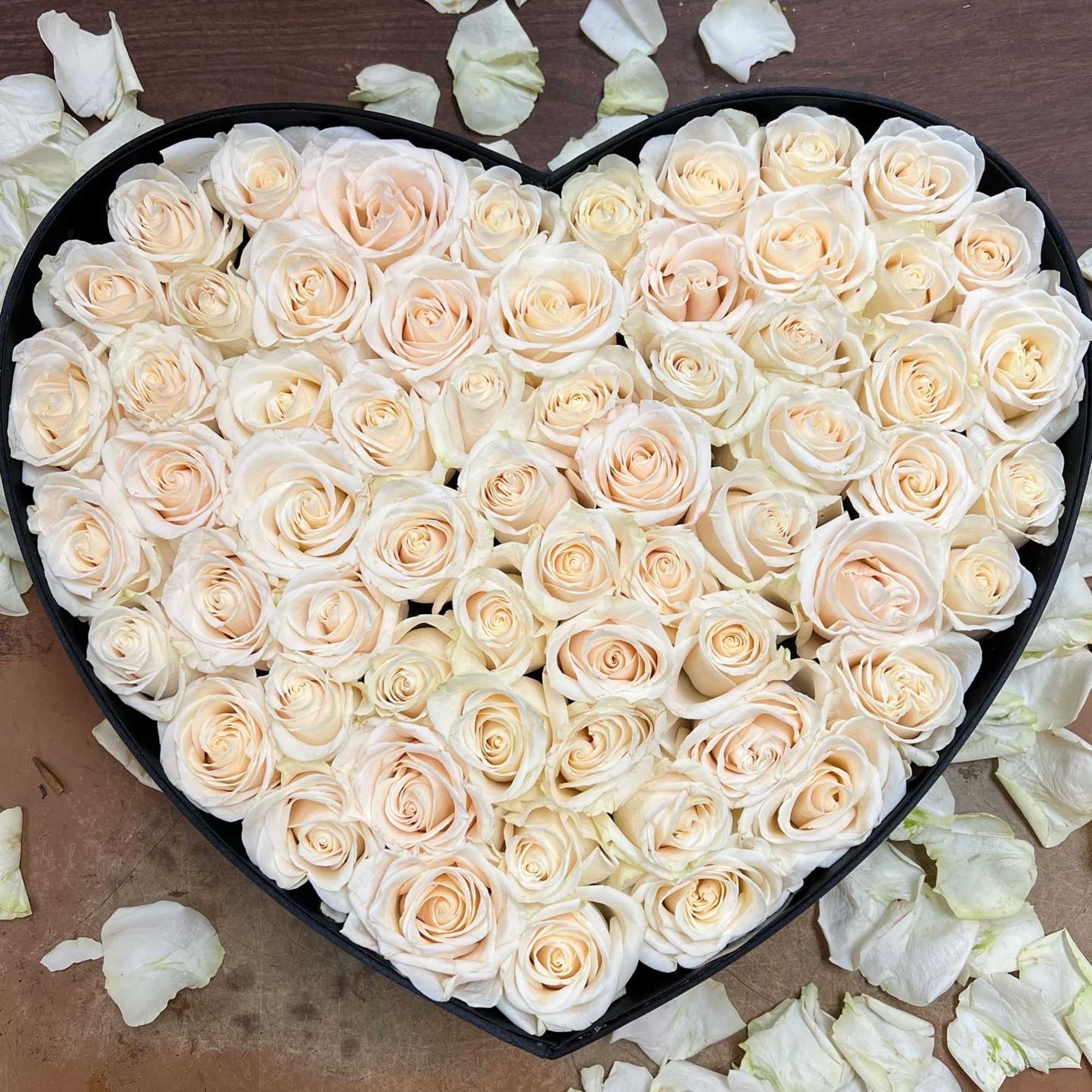 Heart-shaped box filled with cream roses