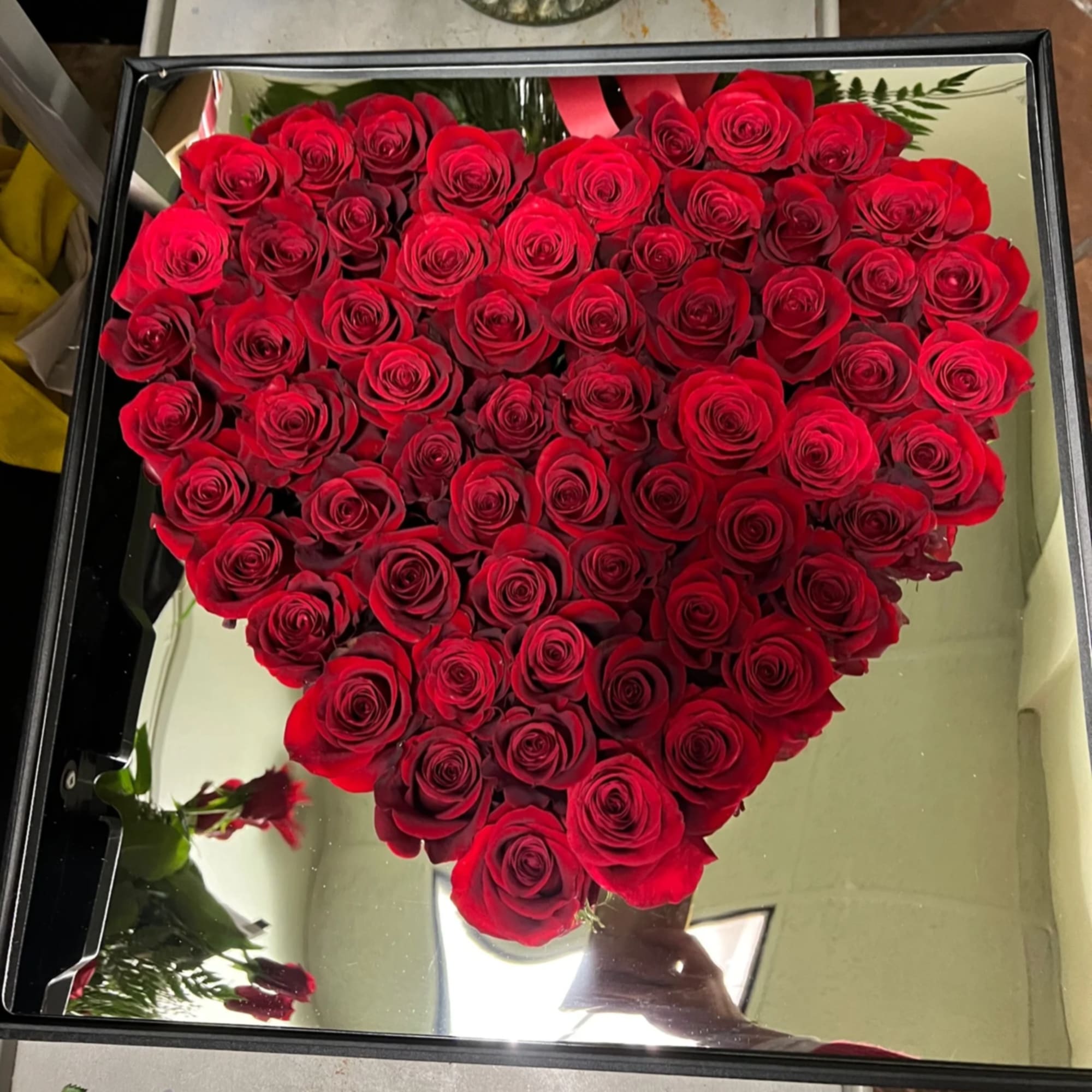 Heart-shaped box filled with red roses